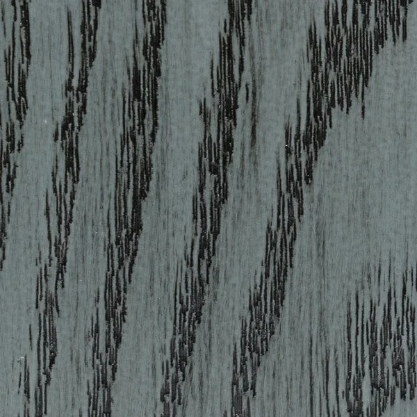 Close-up of gray wood surface with black streaks and grain pattern.