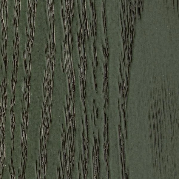 Close-up of a wooden surface with dark, vertical grooves and a greenish tint.