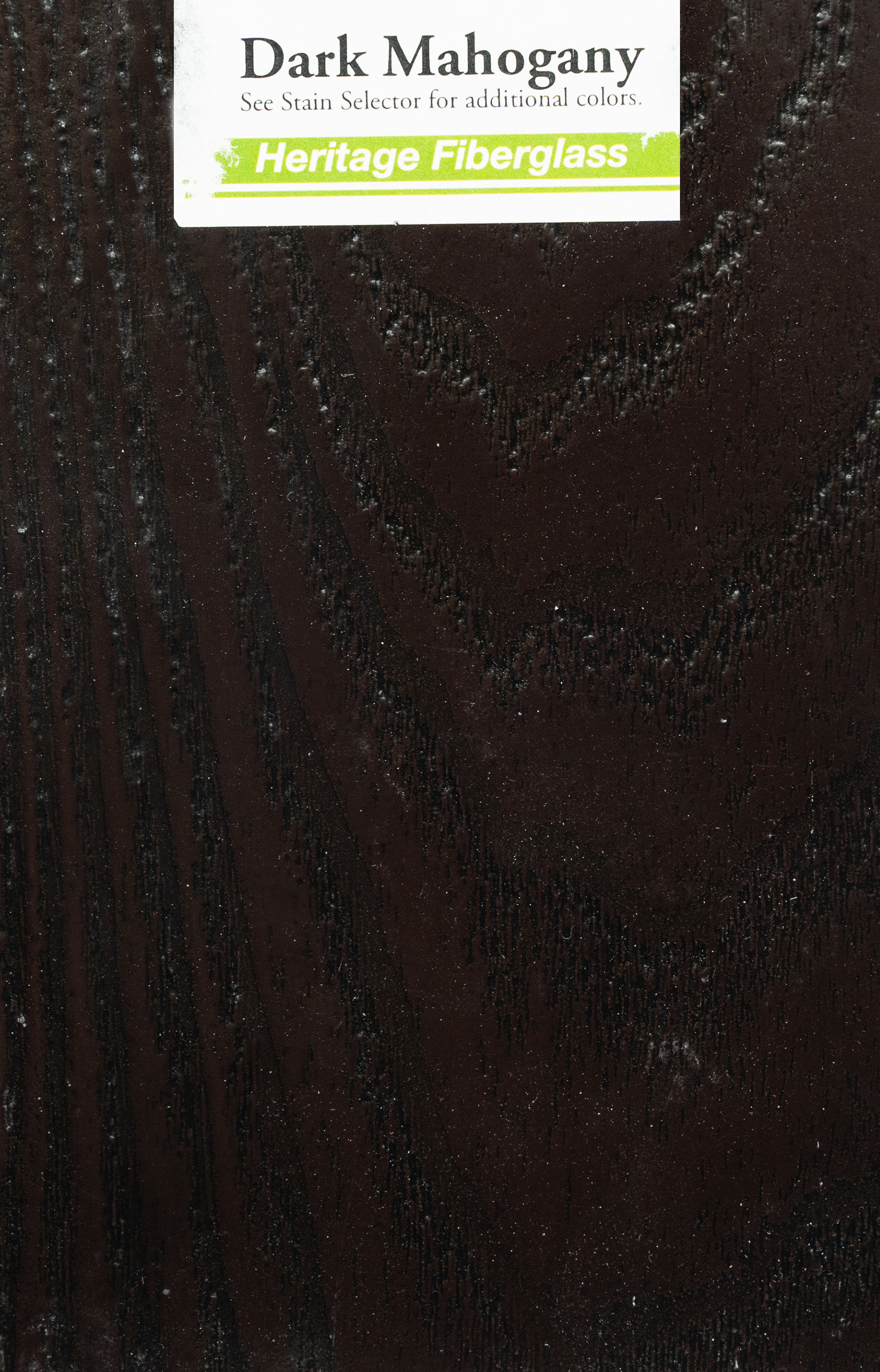 Sample dark mahogany colored wood grain laminate with a label showing "Dark Mahogany" and "Heritage Fiberglass."