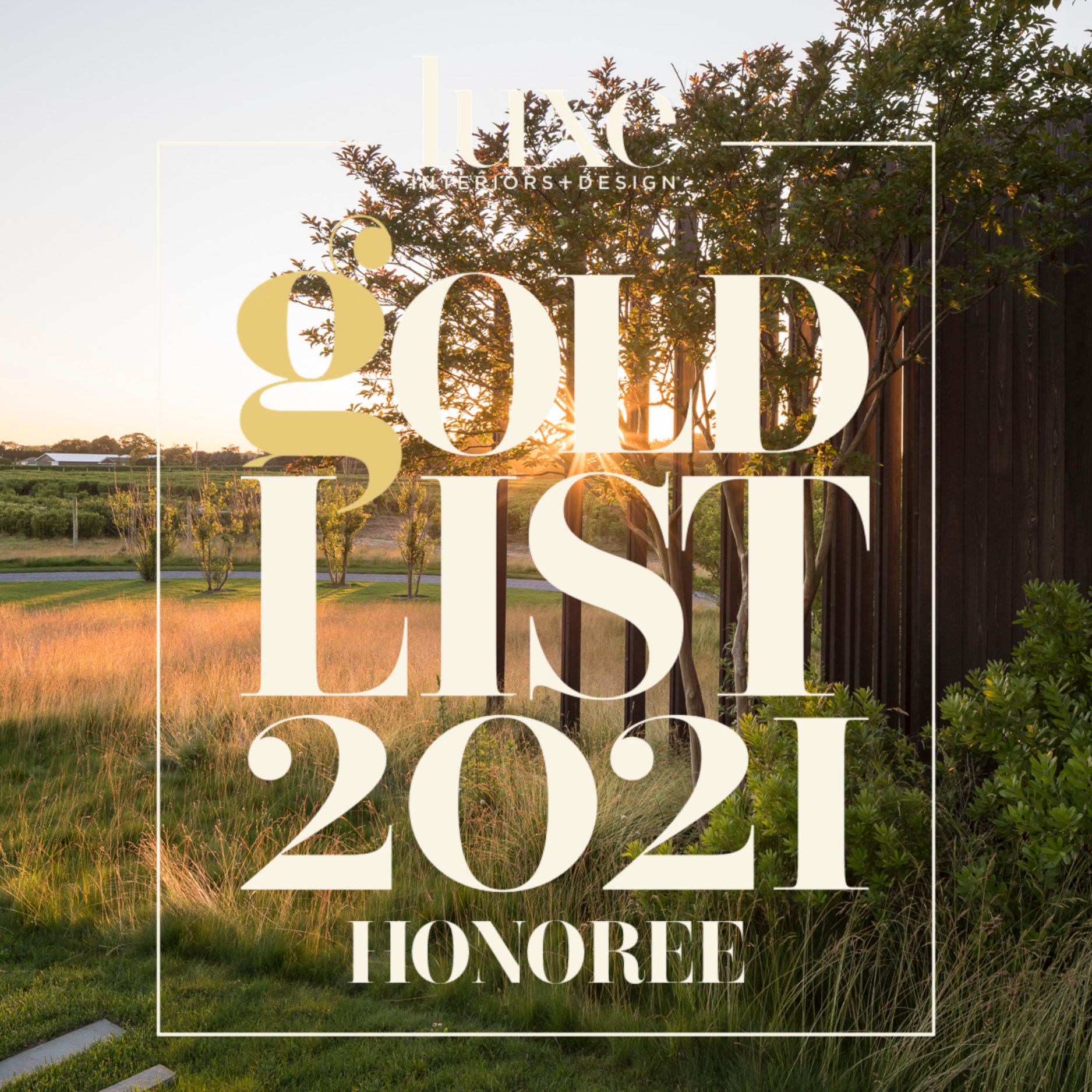 Sunset view of a grassy outdoor area with trees, a wooden fence, and a distant landscape. Overlaid text reads 'HLC Interiors + Design' at the top, and 'GOLD LIST 2021 HONOREE' in large font in the center.