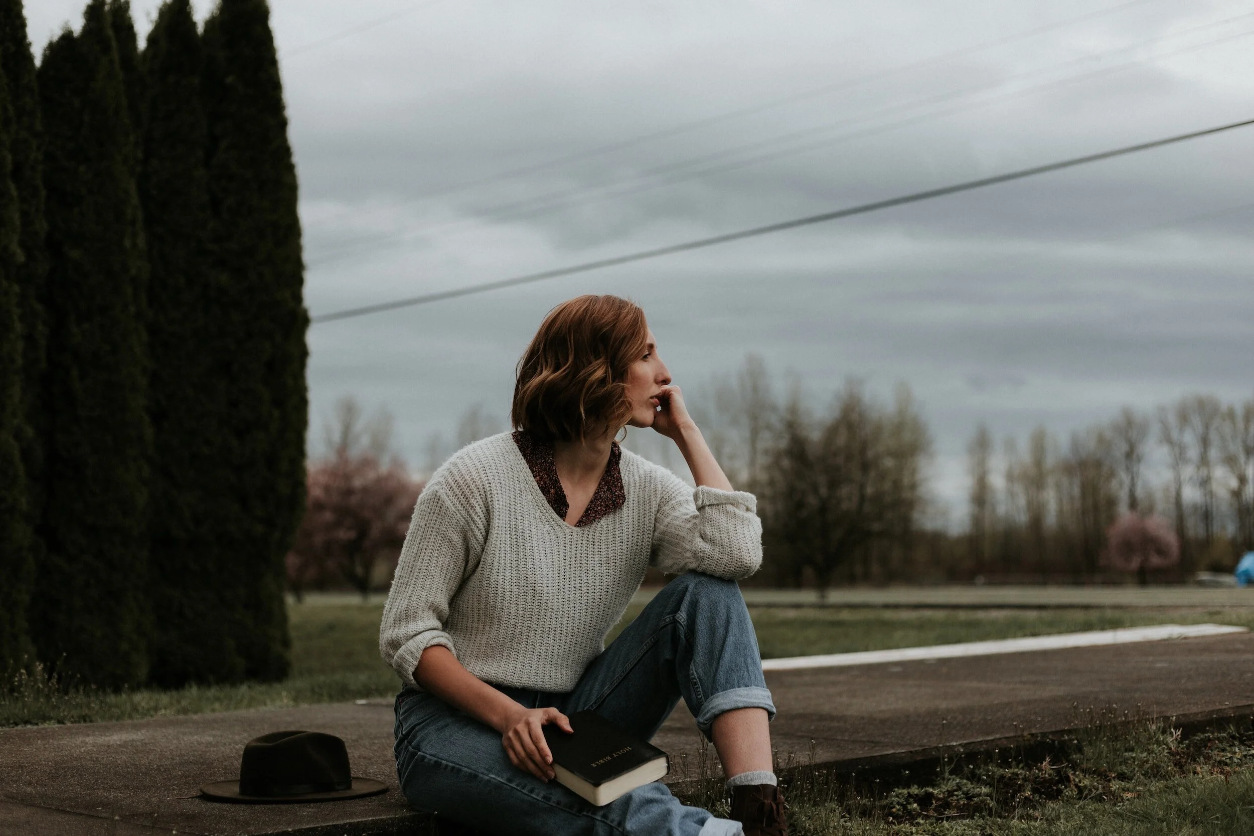 A woman sitting by road | Emotion-Focused Therapy