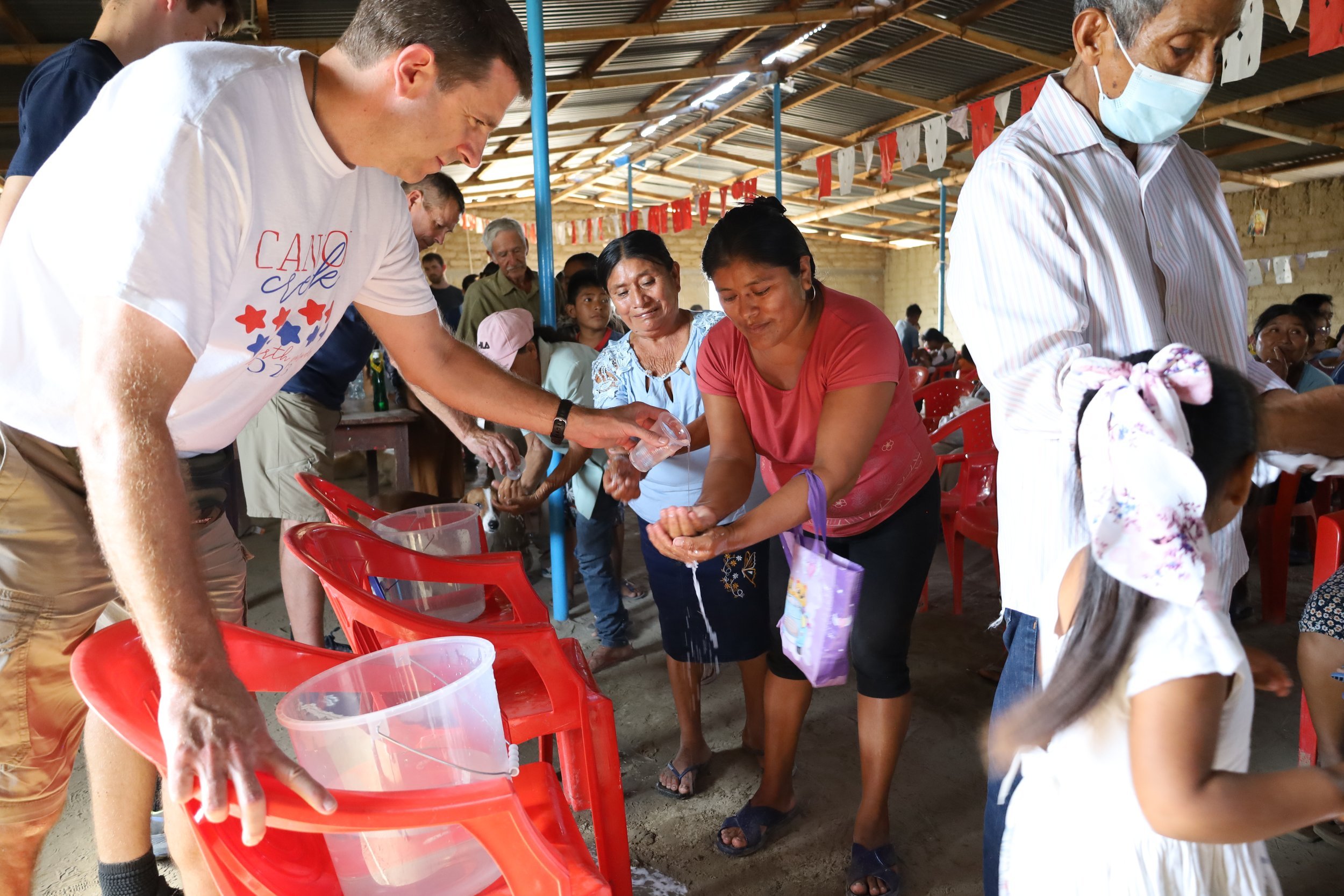 Missionaries run a hand-washing station.