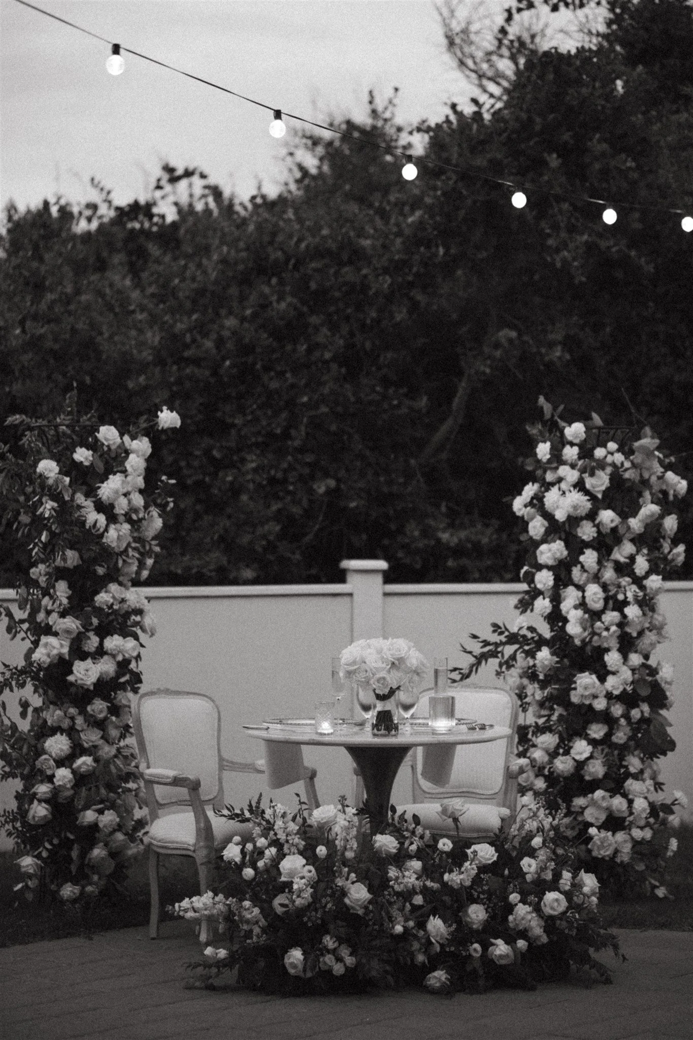 A table rental with upholstered vintage dining chairs at Outer Banks wedding