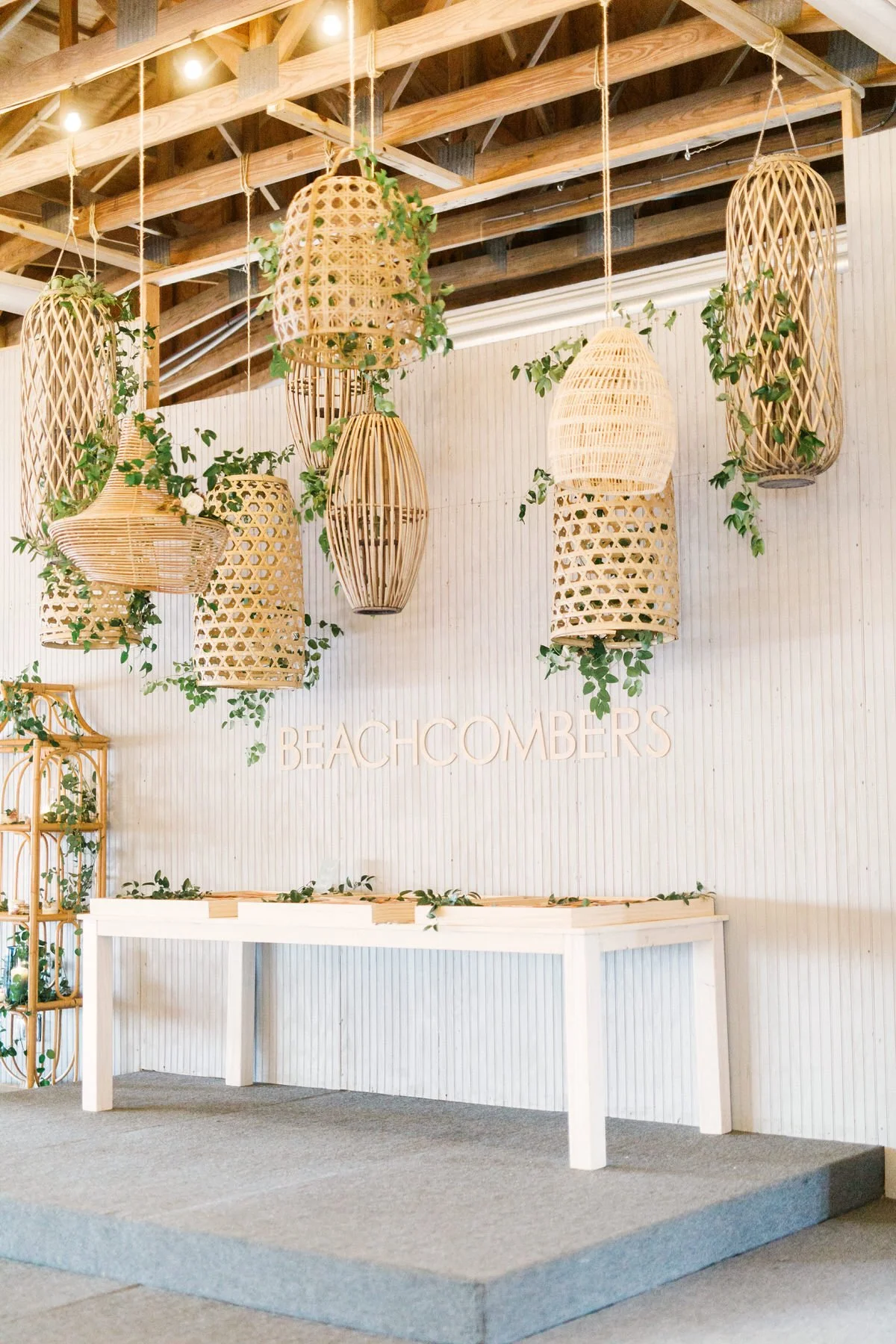 A wedding venue with wicker basket hanging decor suspended from the ceiling.