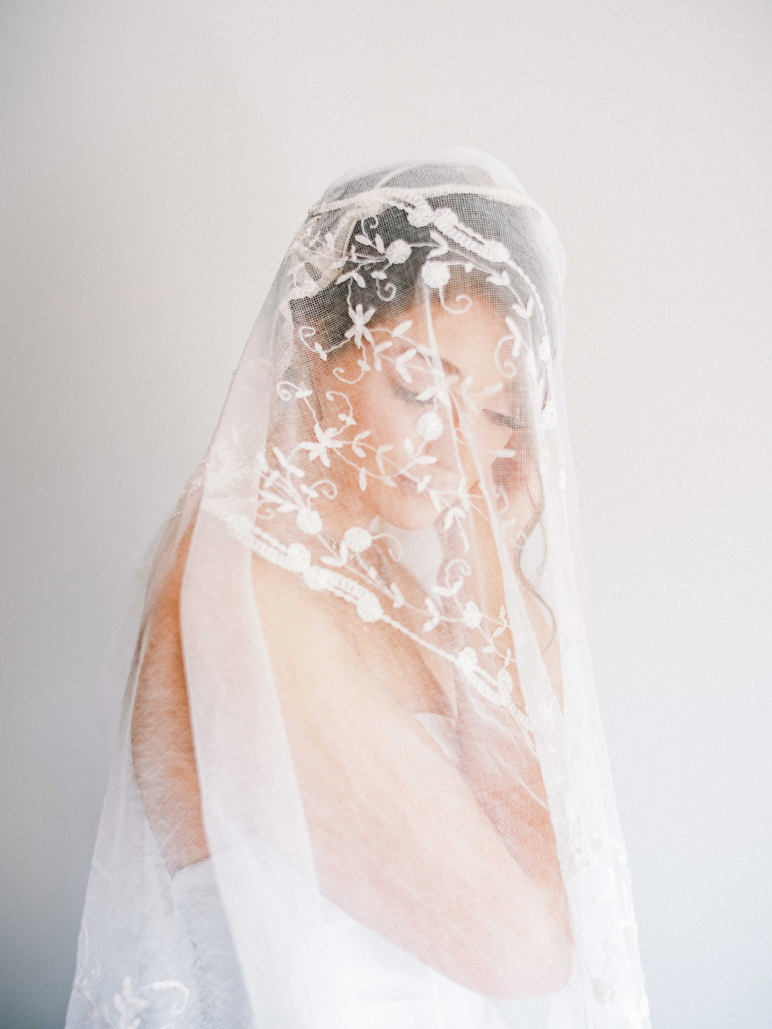 Bride in a lace veil before her Nashville wedding, photographed by Brandon Chesbro