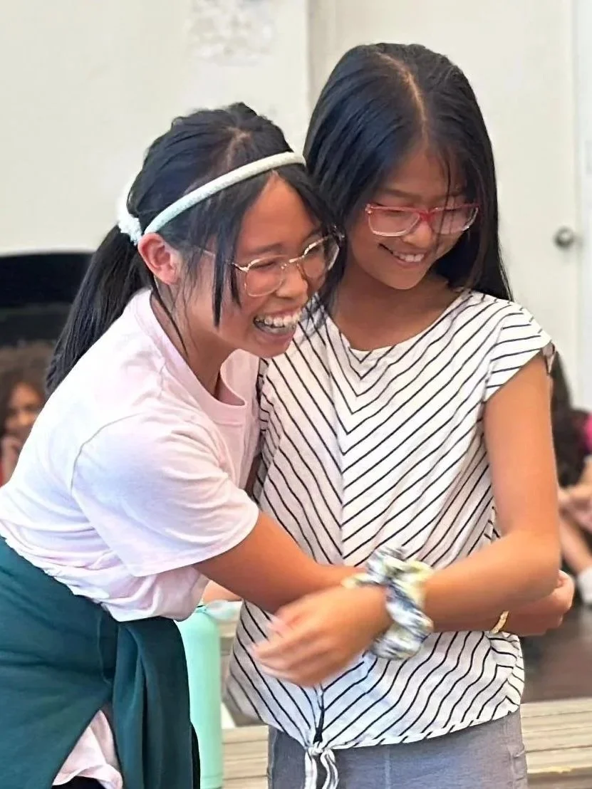 Two Star collective students laughing during a musical theatre class in South Surrey