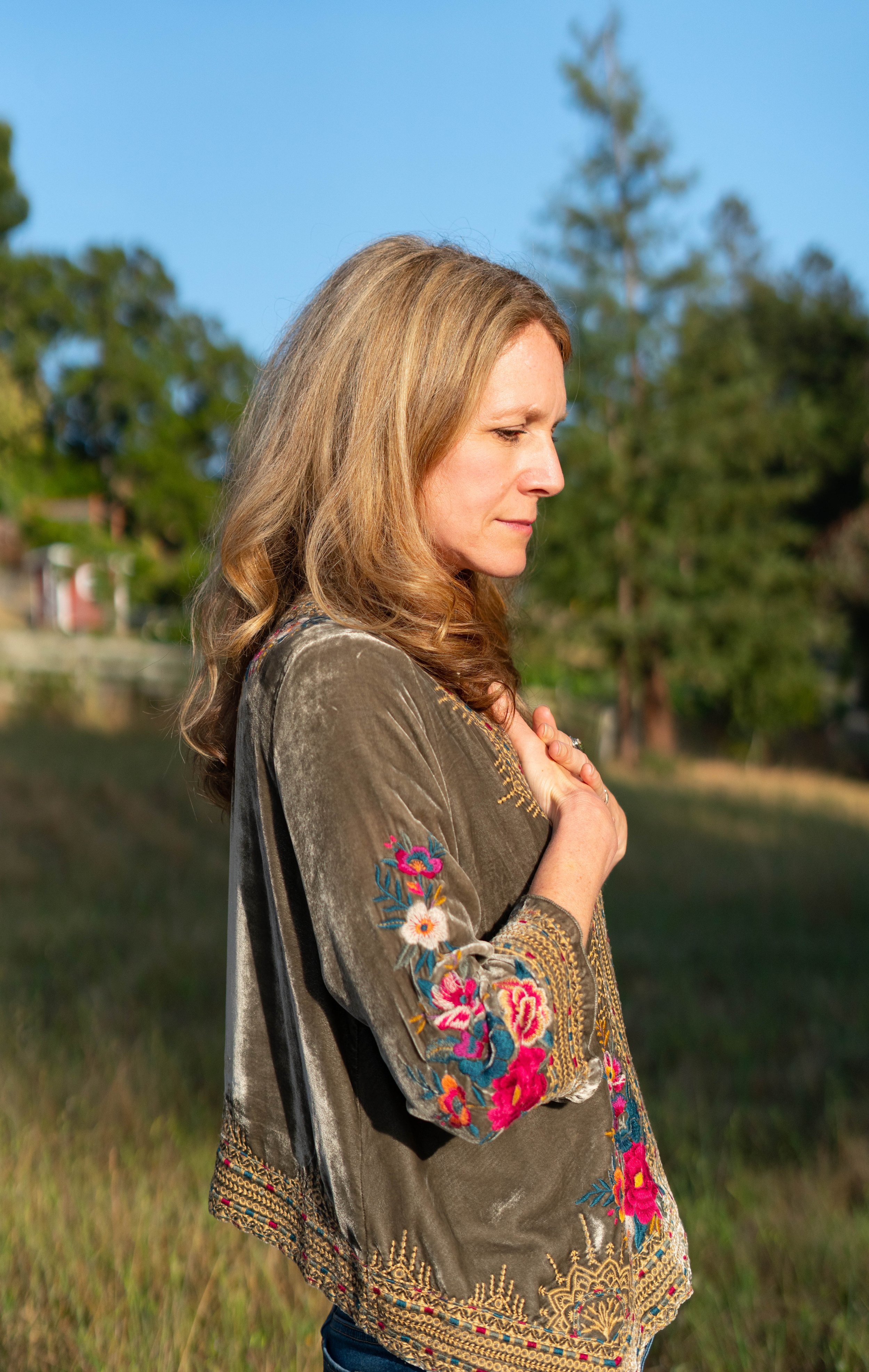 Woman with hands on heart wondering should I stay or leave my relationship