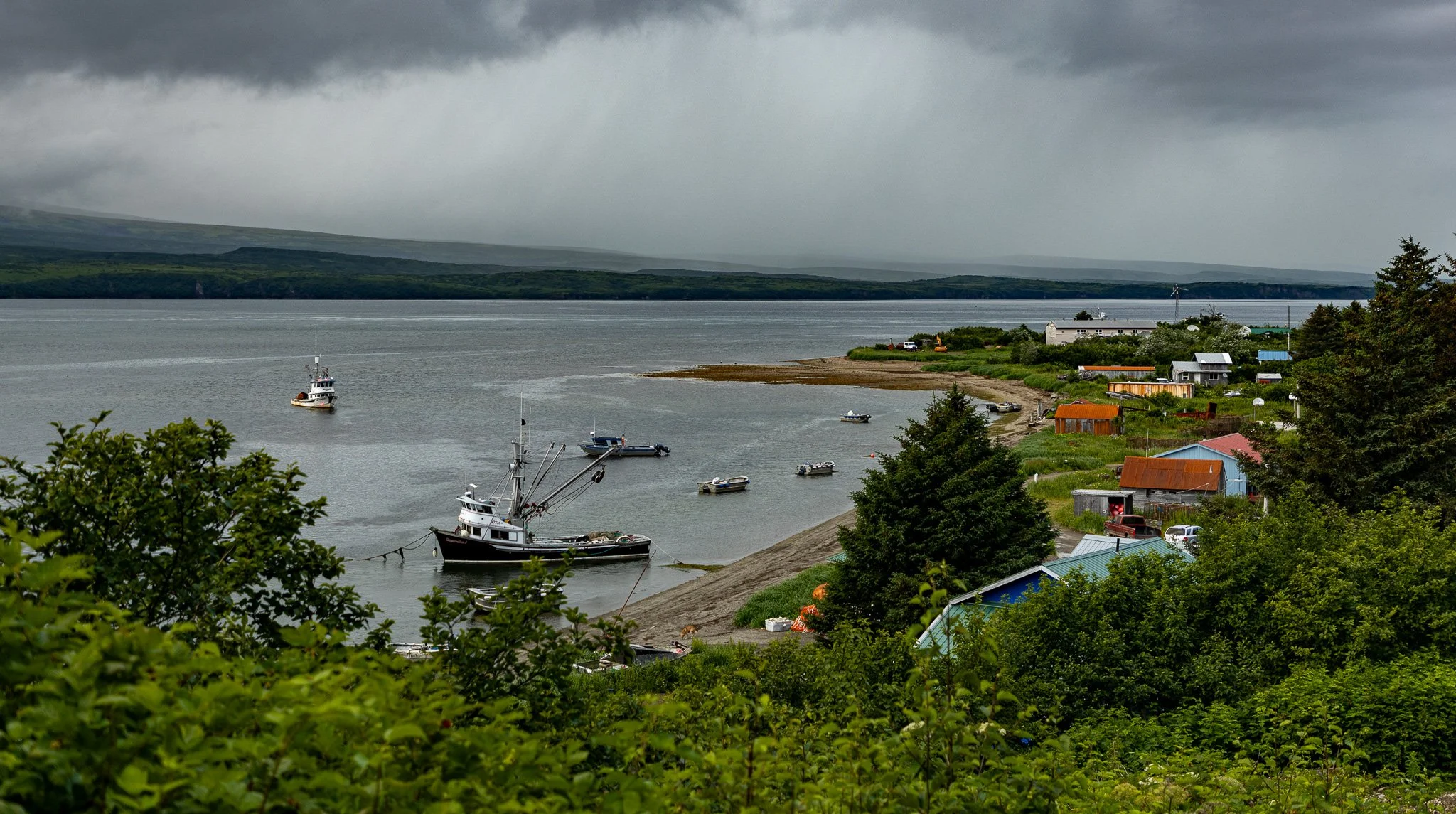 Boats anchored as rain clouds come through.