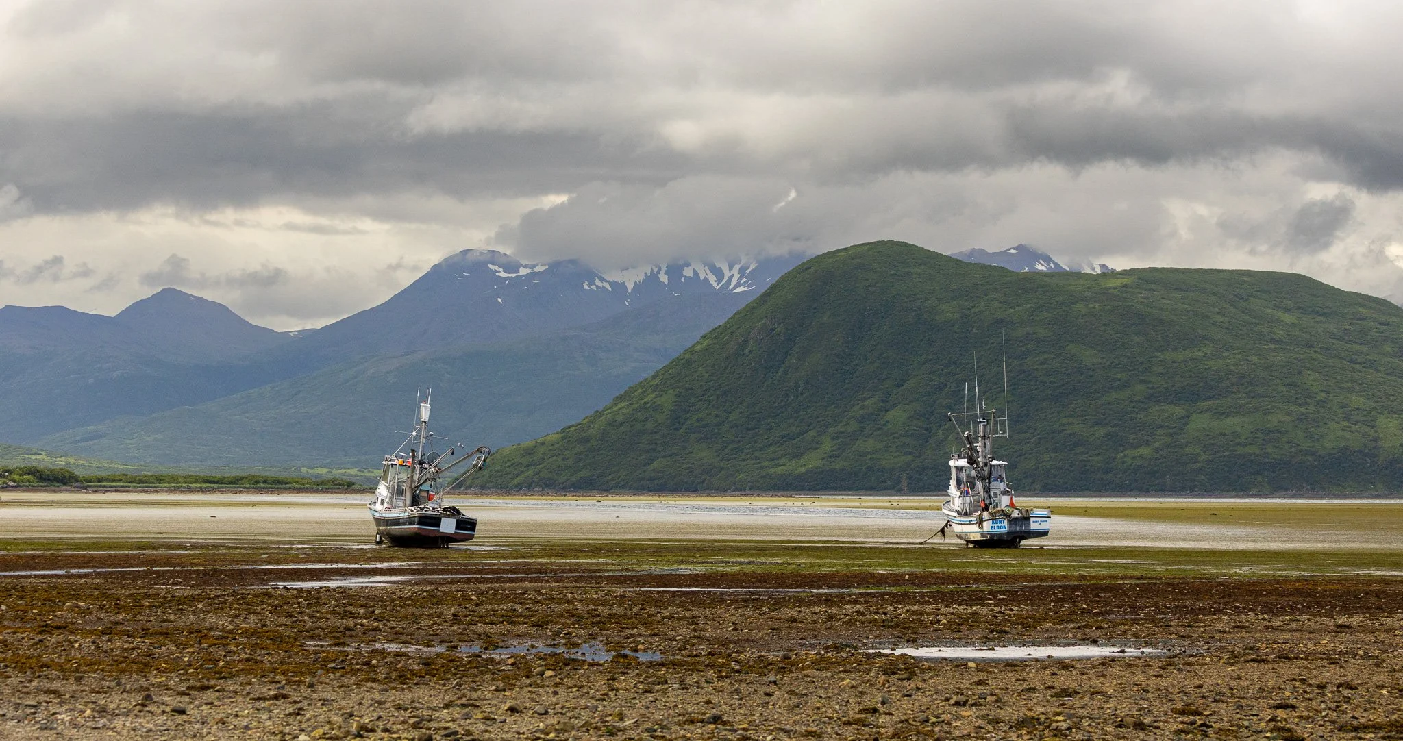 Boats on land at low tide.