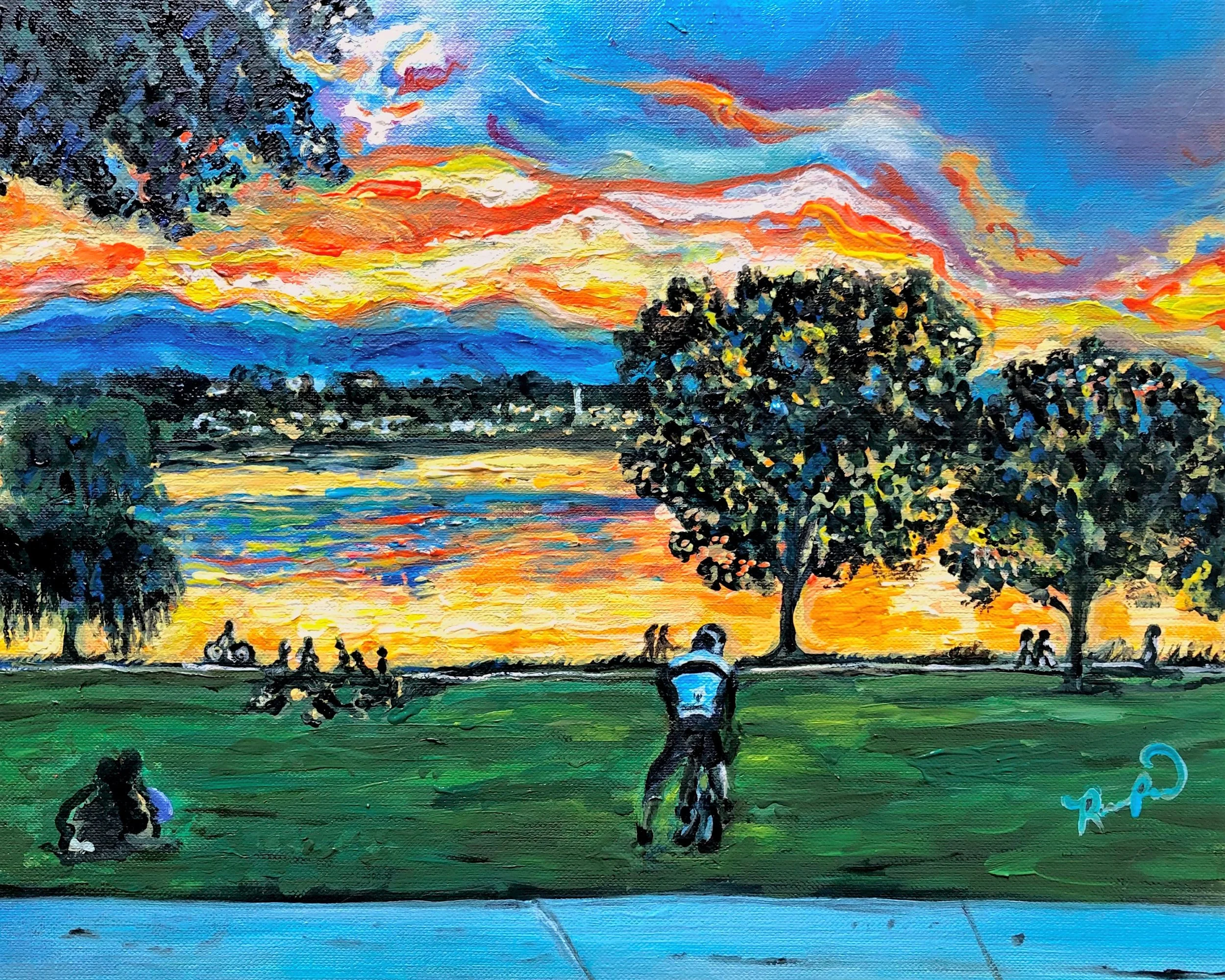 An impressionist-style painting of a sunset over a body of water with silhouettes of trees and people.