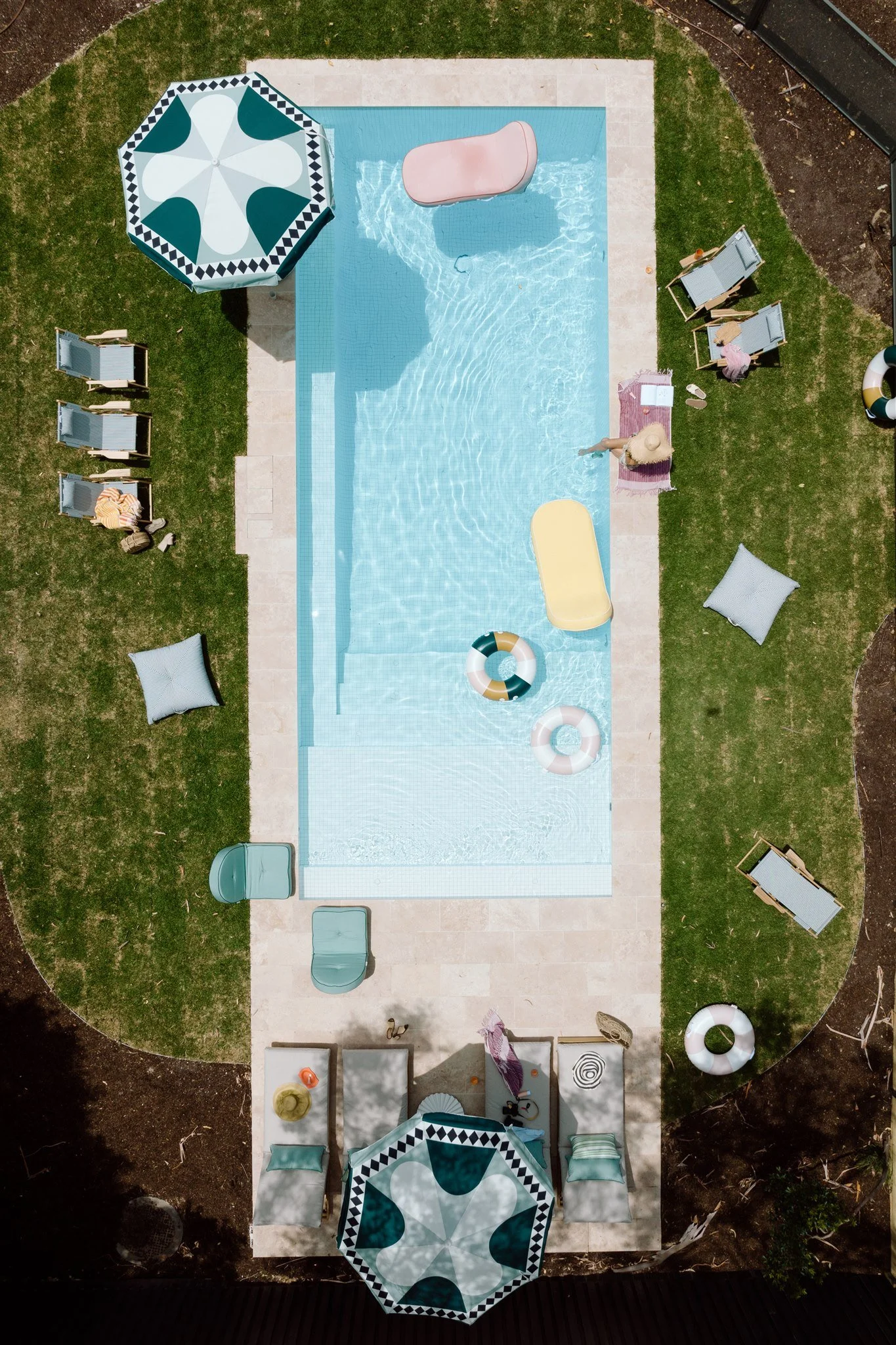 Aerial view of Sagres's private garden pool with daybeds and umbrellas