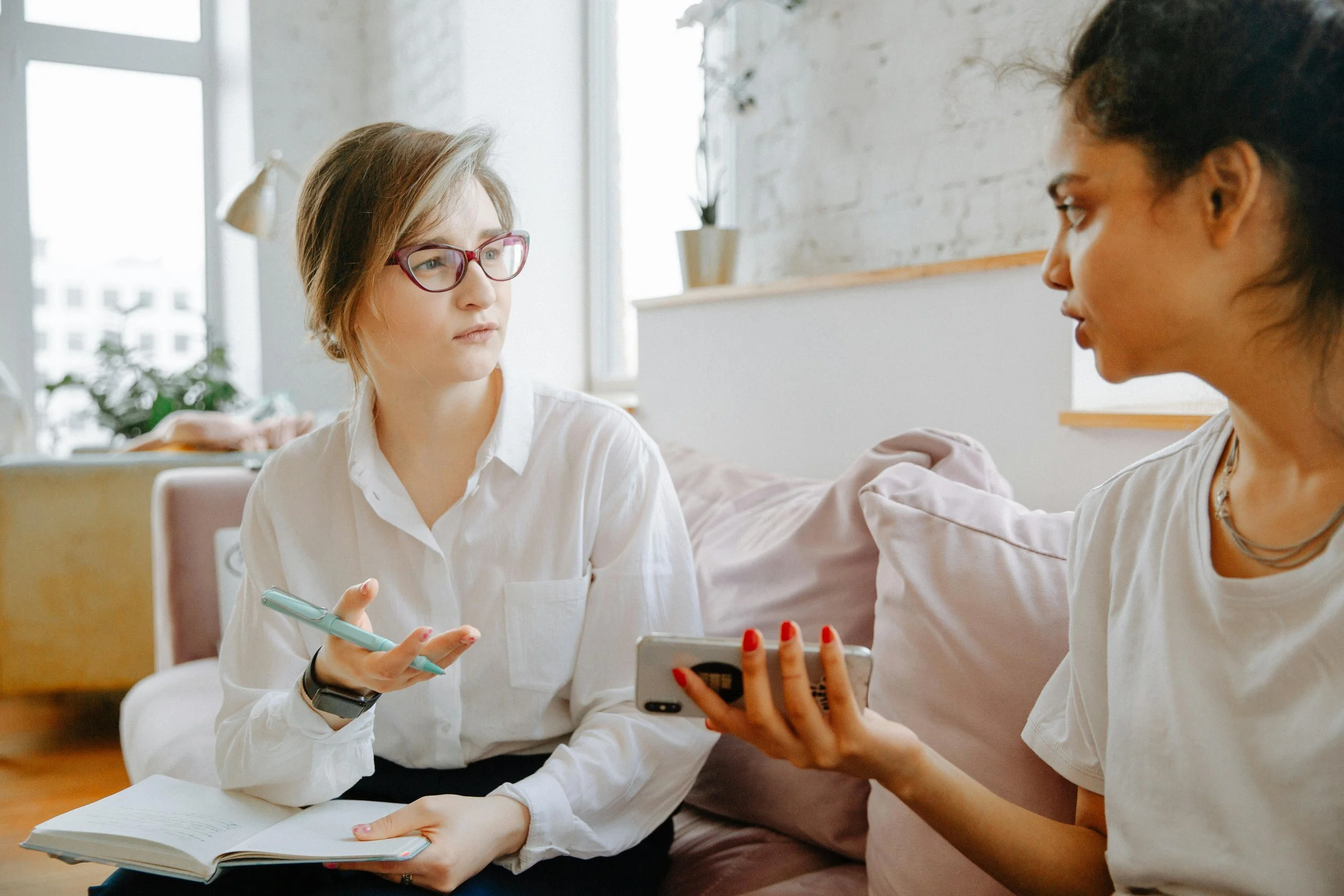 Teen talking with a therapist in a calm, welcoming therapy office during a counseling session.