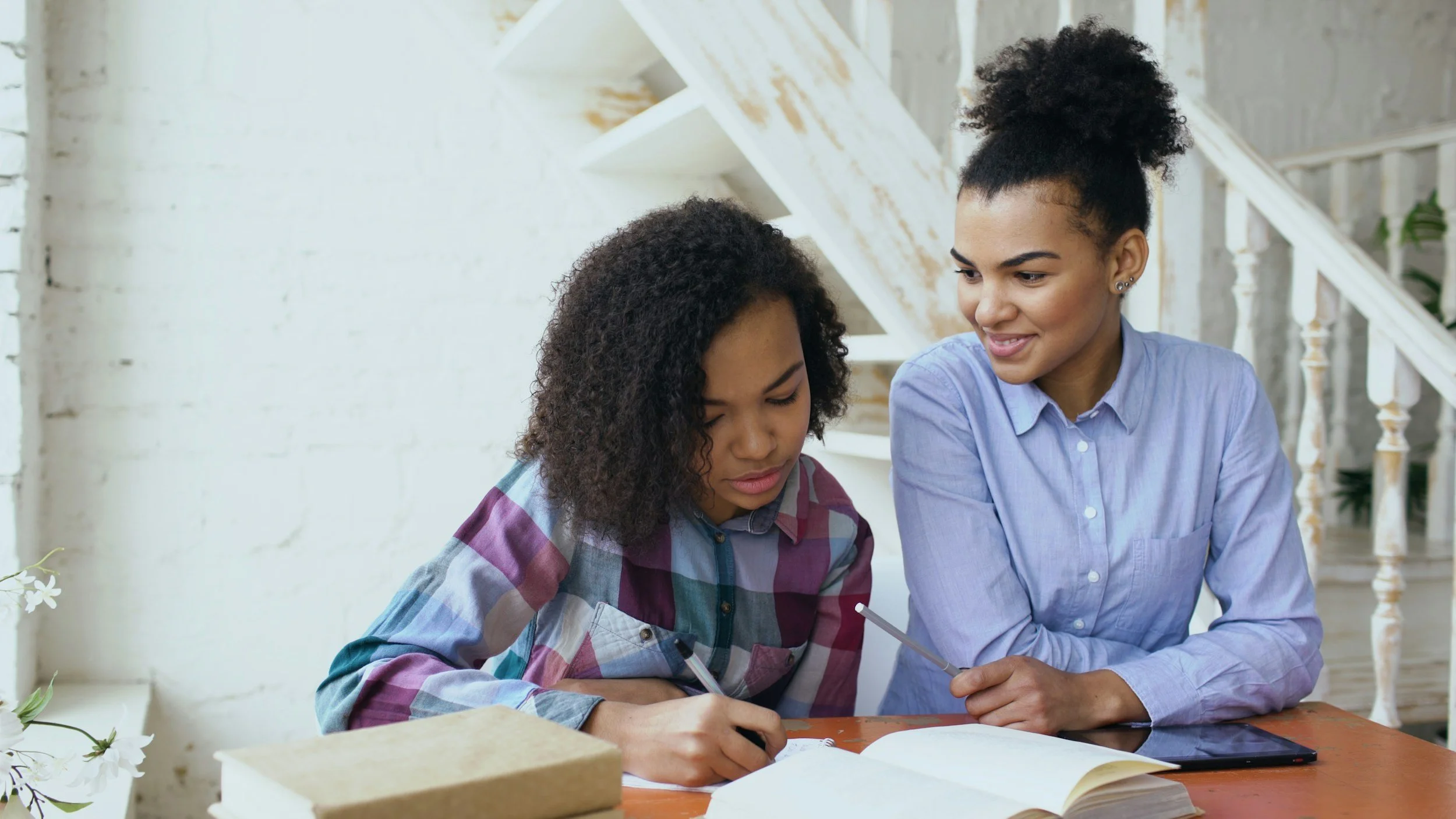 Teen and mother studying together in a calm environment, supporting ADHD management and academic success