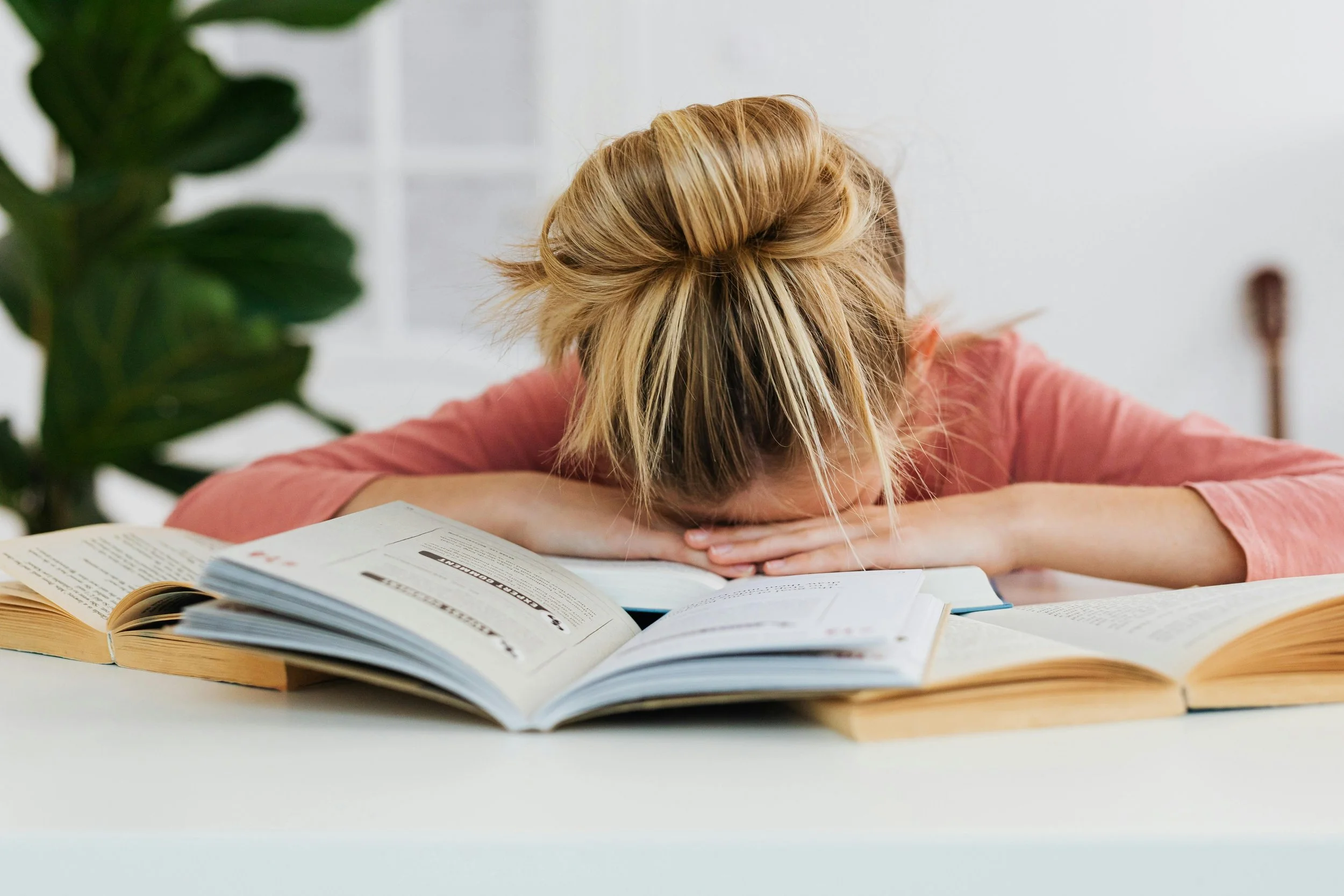 Stressed teen at a desk, representing teen mental health challenges