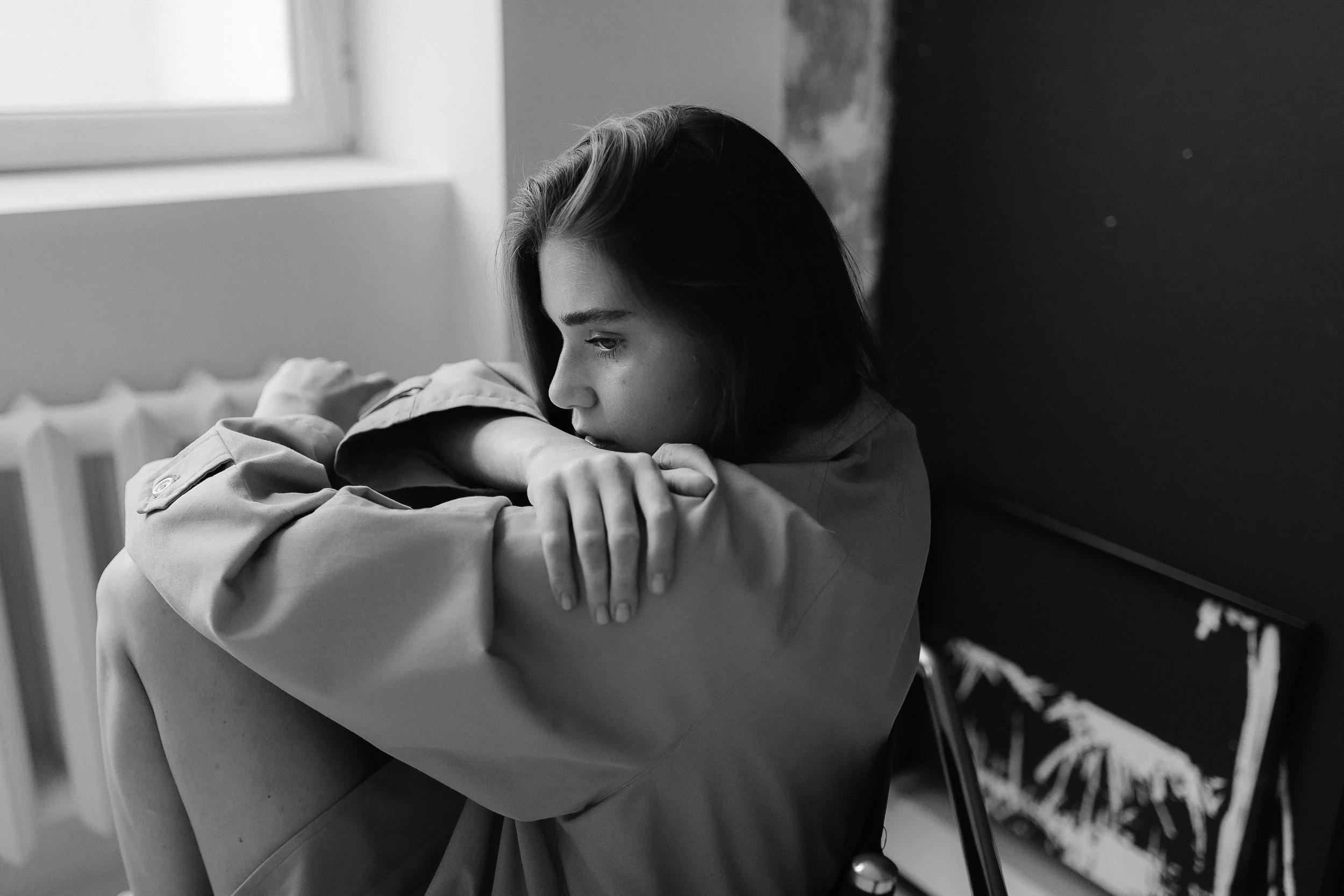 Black and white image of a thoughtful teen showing subtle emotion, representing mental health wellness and counseling support in Arizona