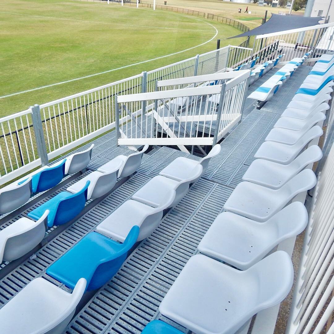 Tiered bucket seating with a raised deck platform &amp; access stairways for spectators - designed, manufactured and installed by Steel Post &amp; Rail Pty Ltd, for AFL Queensland.