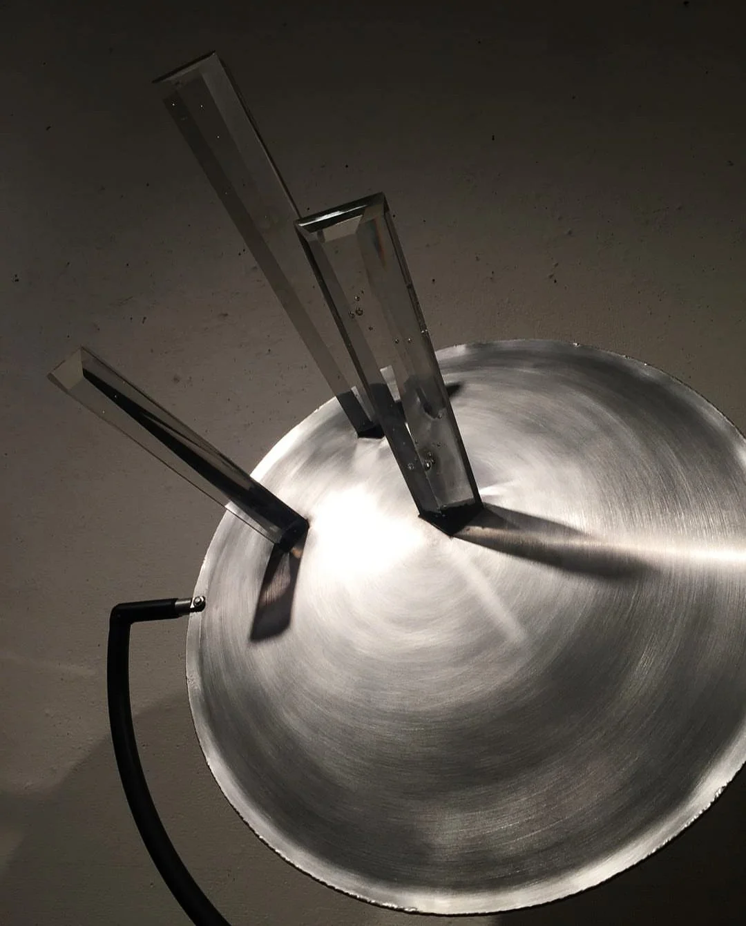 Moon Rays, 2018 : Cast glass solid prisms piercing two hub caps welded together on a metal frame, 6ft in height