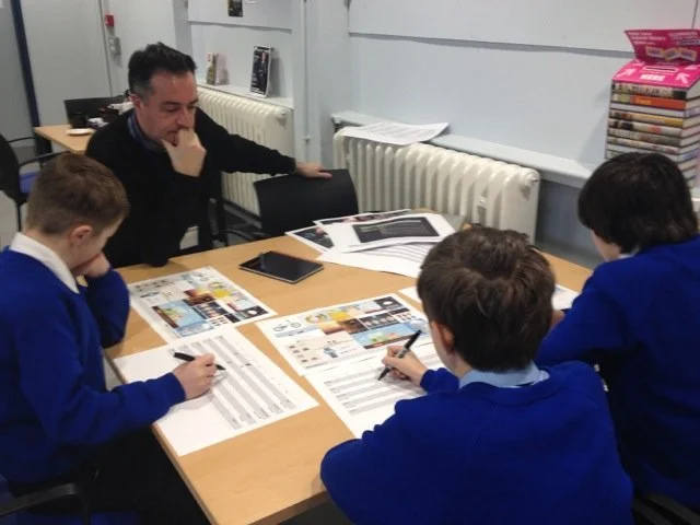 Children in a classroom looking at a prototype