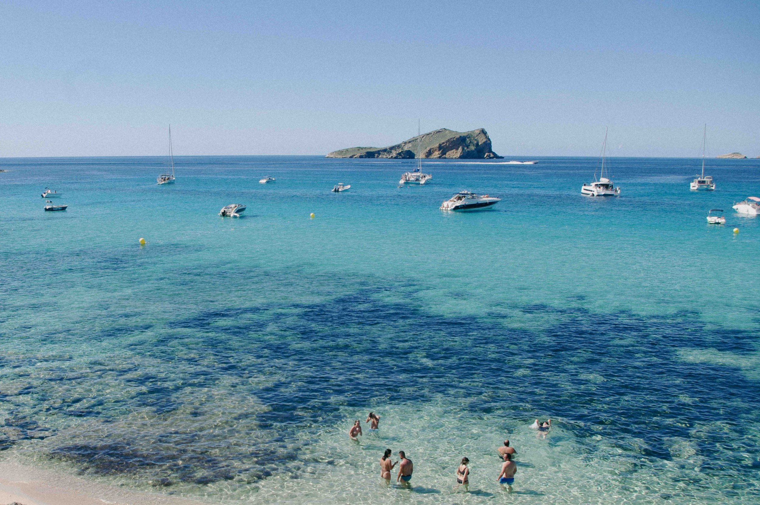 Print artwork of people on a beach in Ibiza. Available framed or unframed in 50x70cm and 70x100cm, supporting 1% for the Planet