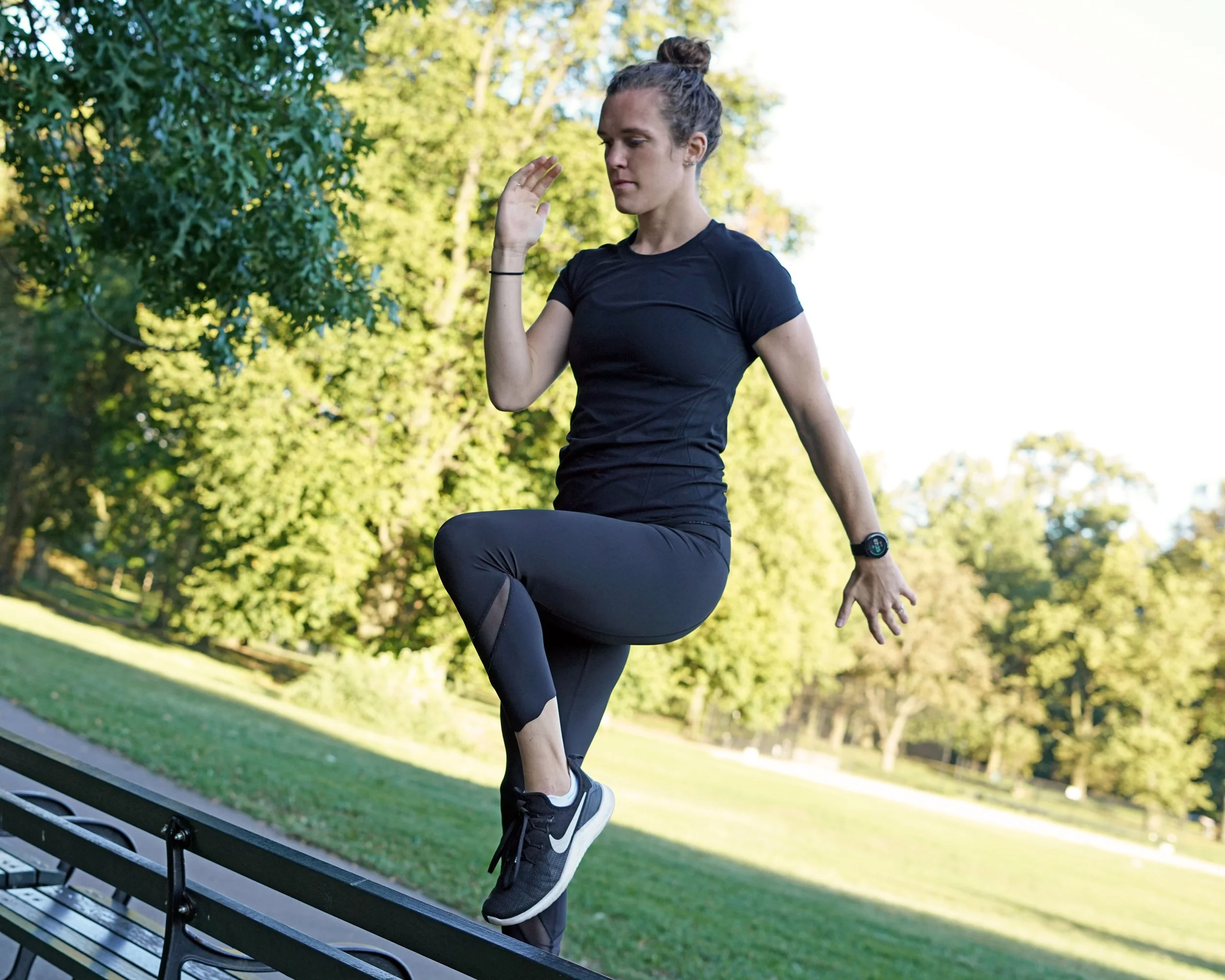 A personal trainer demonstrating high impact exercise for postpartum and menopause strength training for bone health.