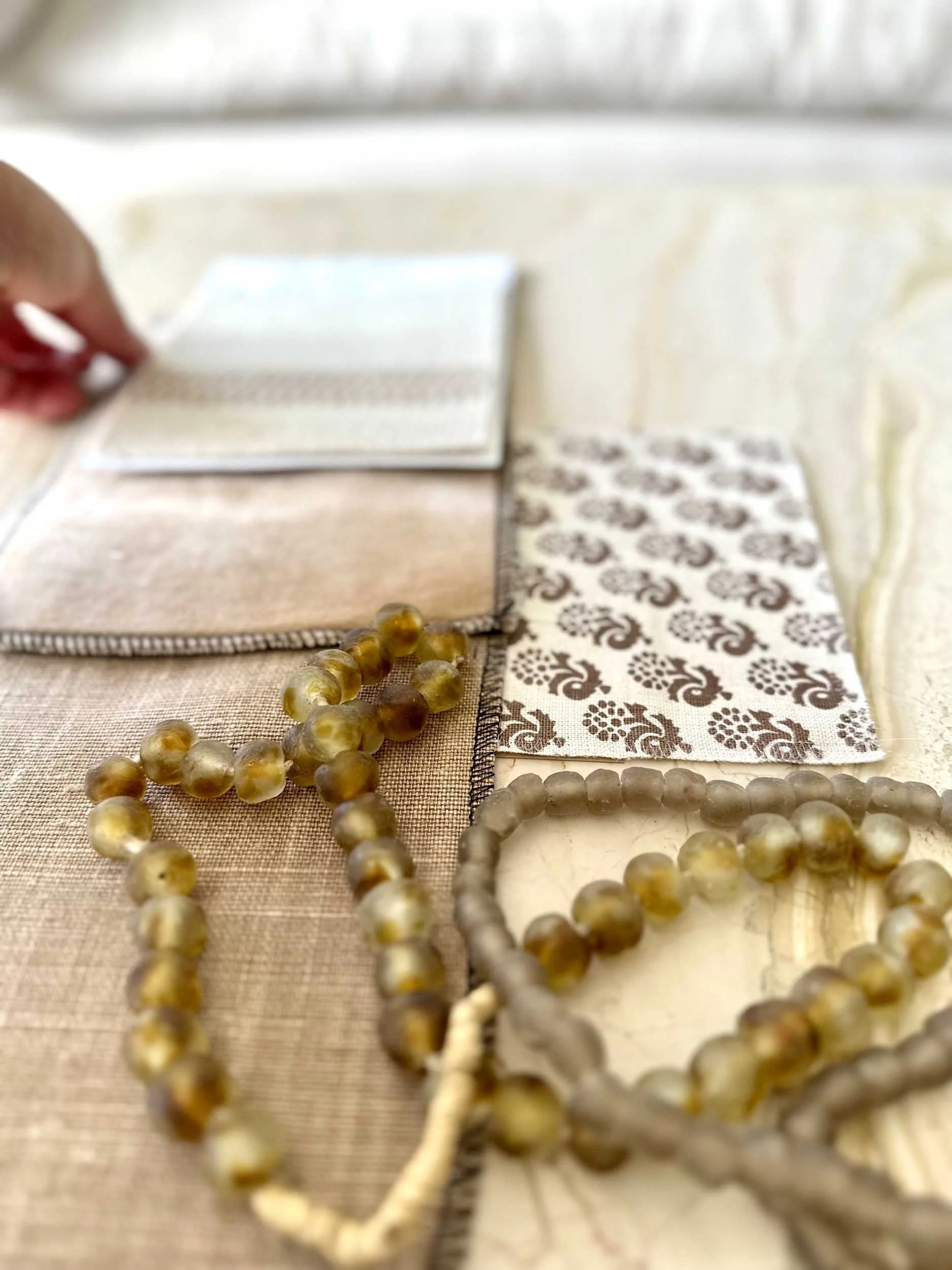 Imparfait Design Studio fabric samples, stones, beads and designer's hand