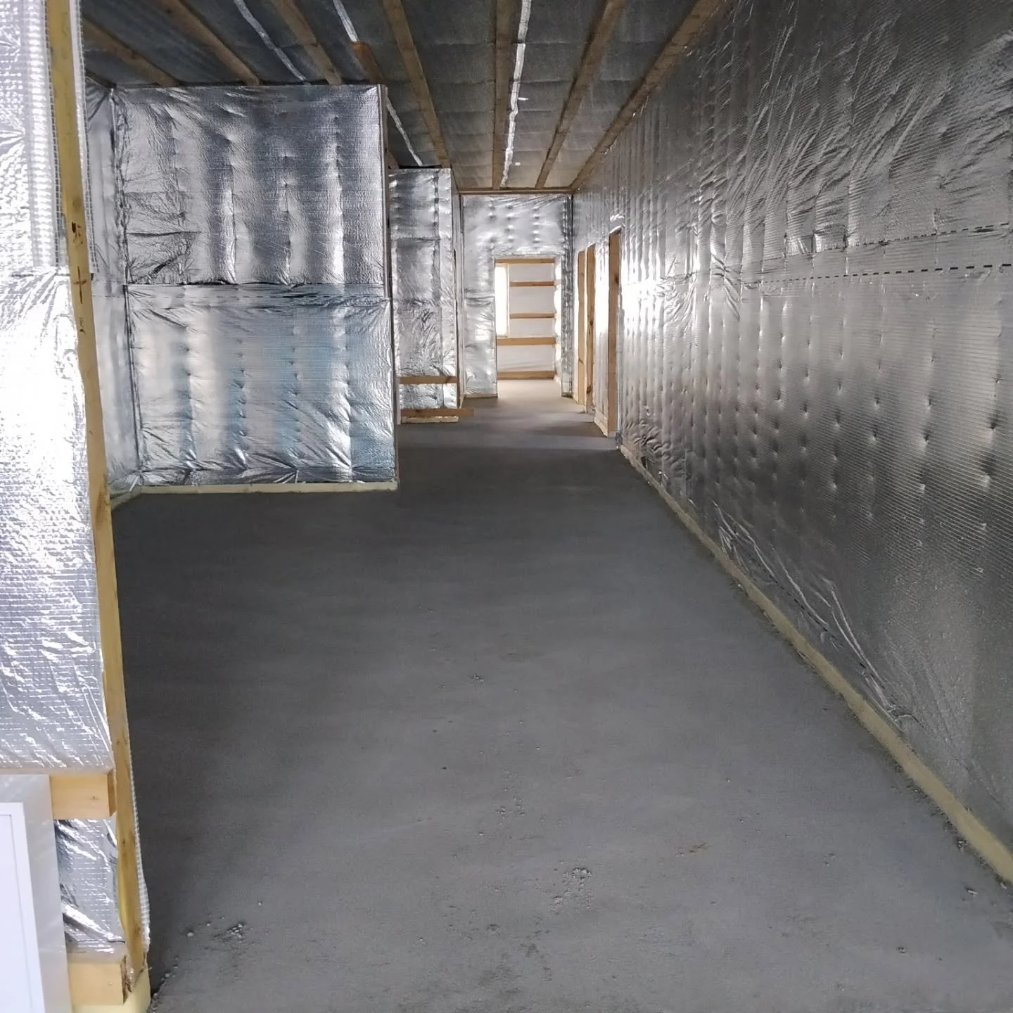 Inside Blossom Cottage. The floor was poured over the under-floor heating pipes. Coming soon, wiring, HVAC,  walls, ceilings, and floors!