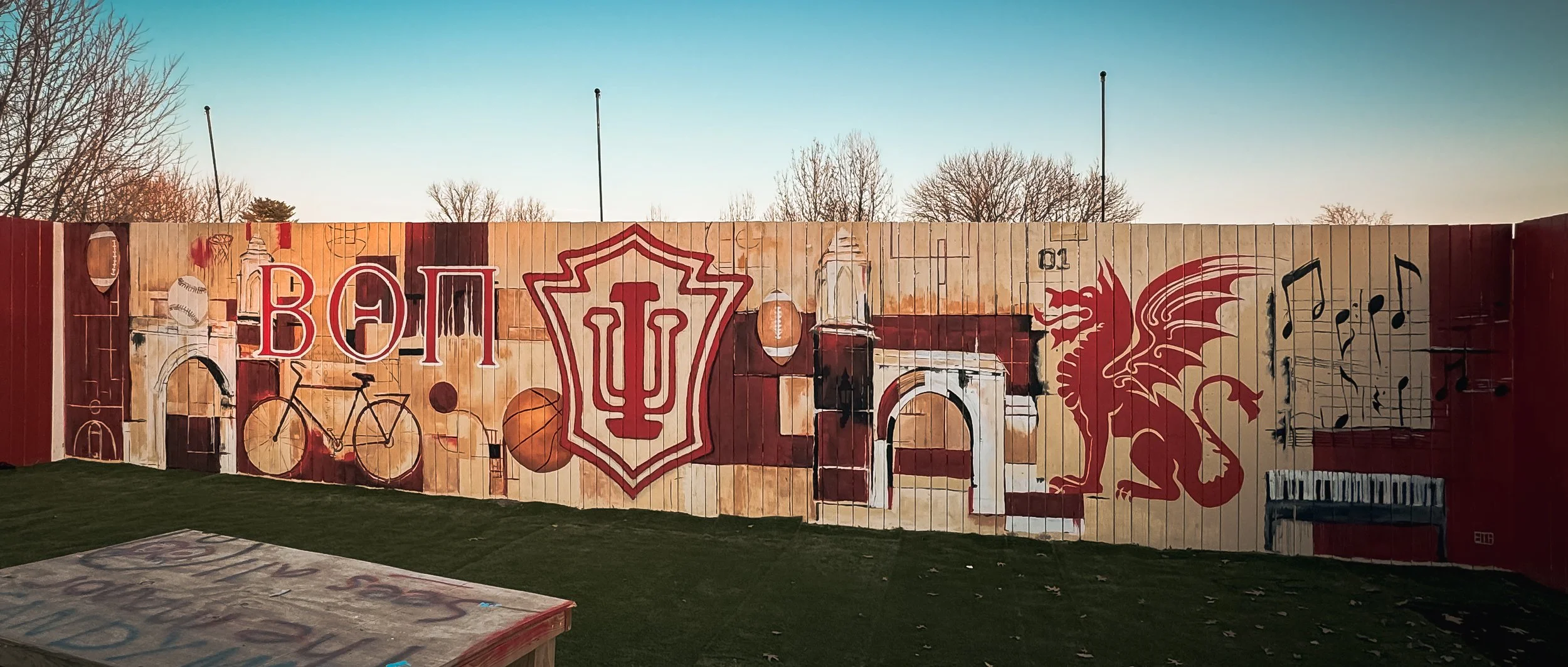 Indiana University-Themed Exterior Mural
Large exterior mural featuring Indiana University imagery alongside sports, music, architecture, and campus-inspired elements in a limited cream-and-crimson palette.