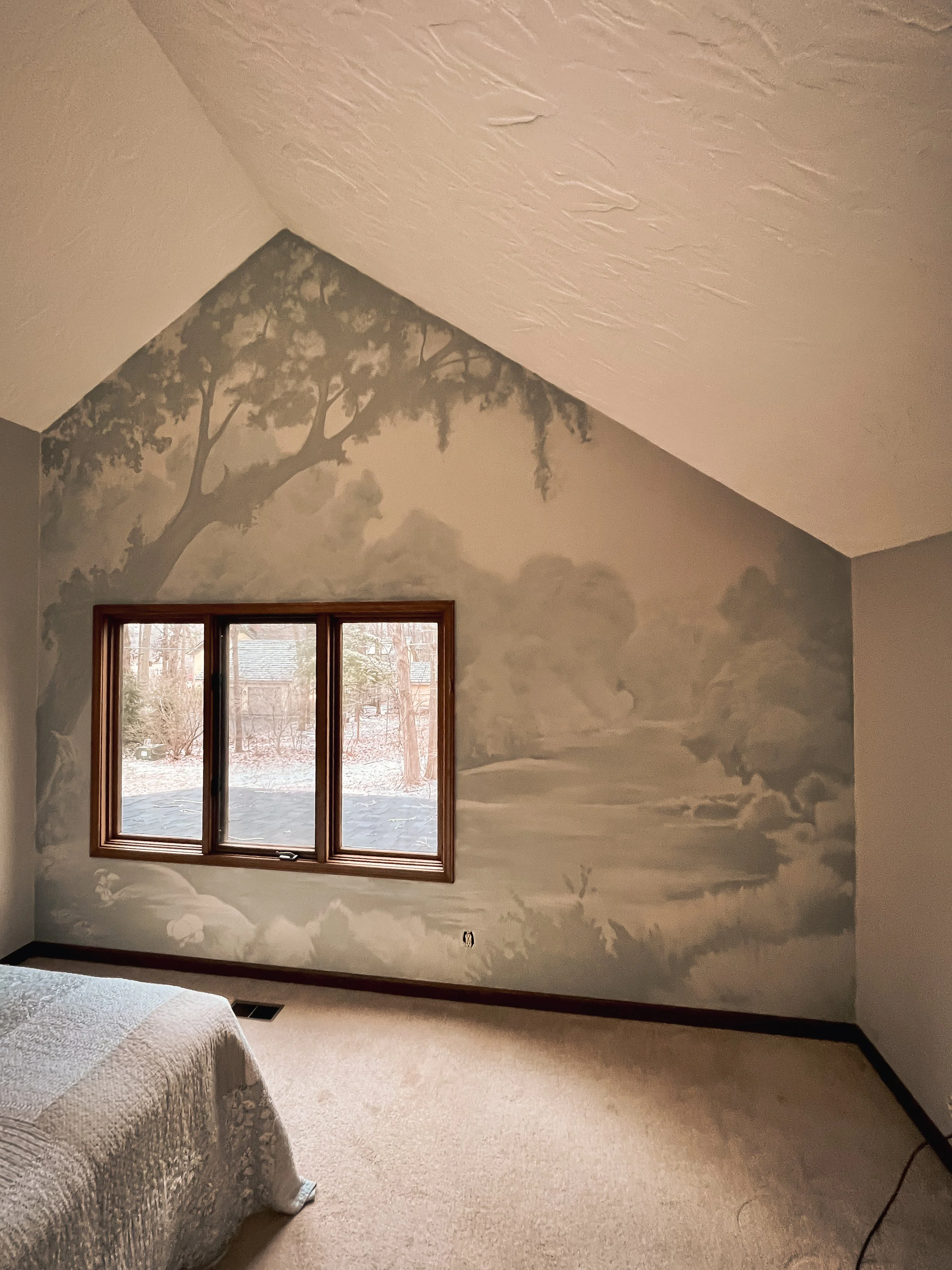 Soft monochromatic bedroom mural depicting an atmospheric landscape with trees, water, distant foliage, and a large tree framing the window.