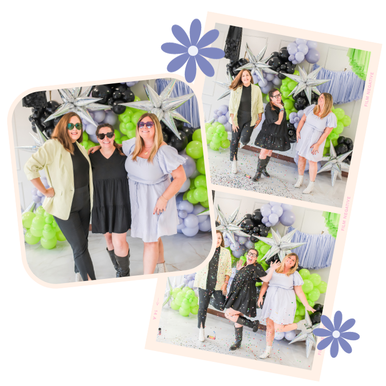 Three women posing for photos in front of a balloon decoration with silver star-shaped balloons and clusters of black, green, and lavender balloons at a celebration or party.