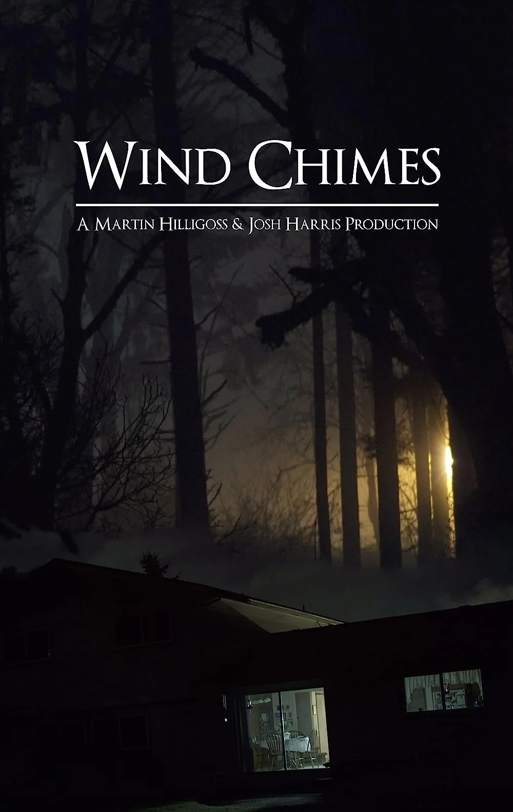 Cover of a book titled 'Wind Chimes' with a dark forest scene, trees silhouetted against a moonlit sky, and a house with illuminated interior in the foreground.