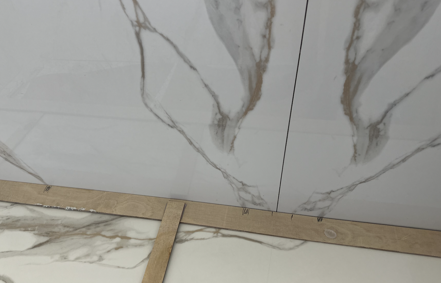 Adam’s marks where the veins from the wall will meet the bench on his wooden template. He calls this a “story stick.”