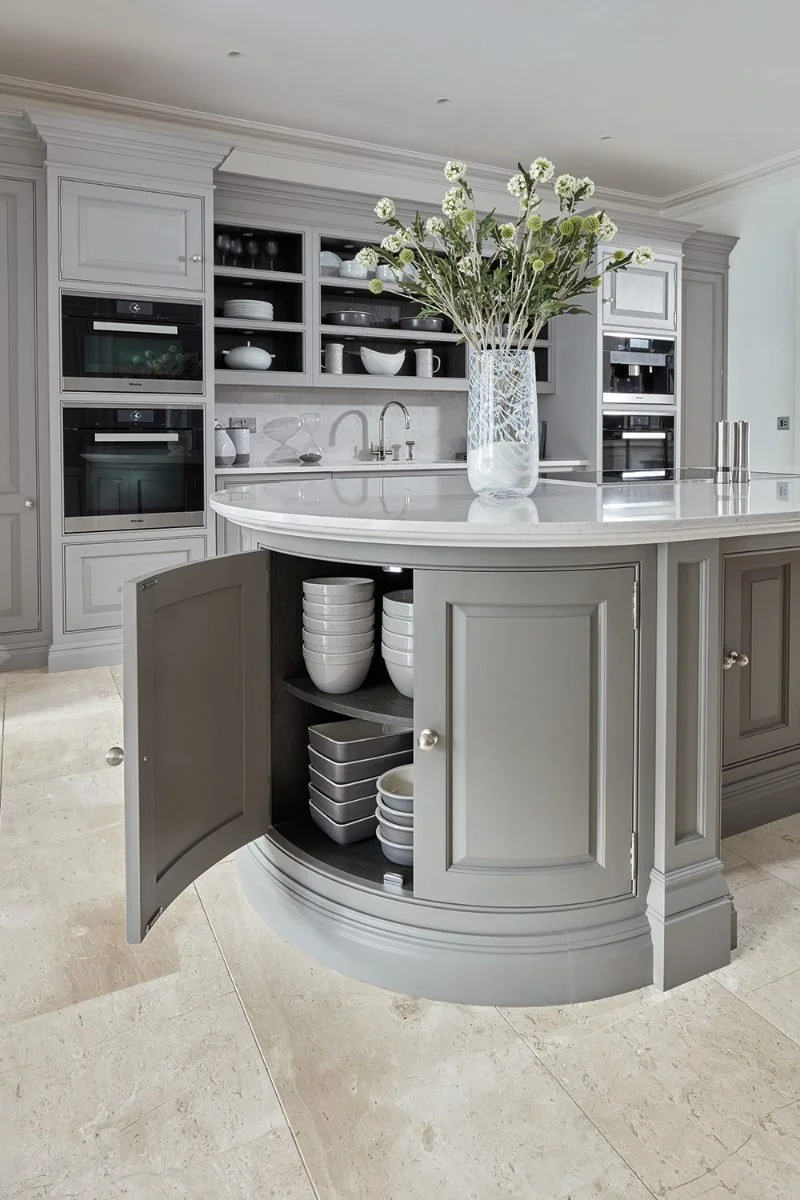 This traditional Shaker-style island in a muted grey, from luxury British kitchen maker Tom Howley , features a contemporary twist with curves at either end.