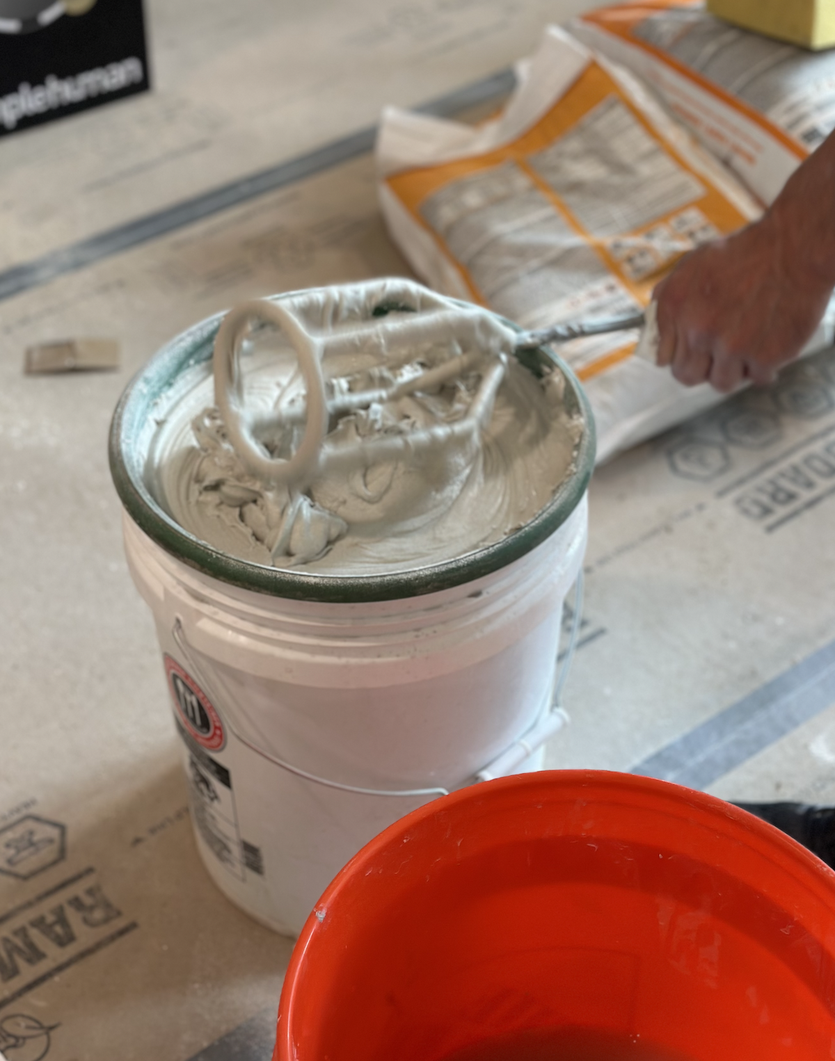 Fresh Bostik Bosti-set, a newer type of adhesive that gauged porcelain installers now prefer, is mixed for each panel application.