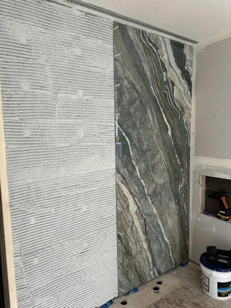 Bosti-set is applied to a wall before the gauged porcelain panel is applied.
