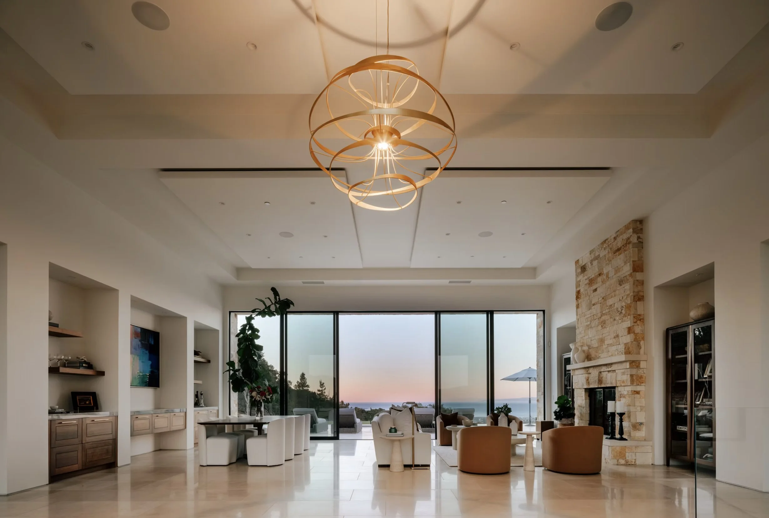 Modern open-concept living space with kitchen, large windows, and ocean view.