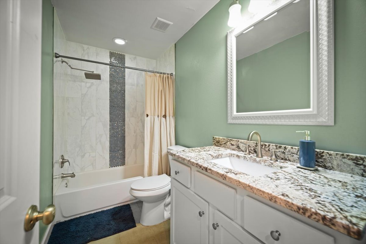 2032 Inwood Terrance Updated Bathroom with tile and granite countertops.jpg