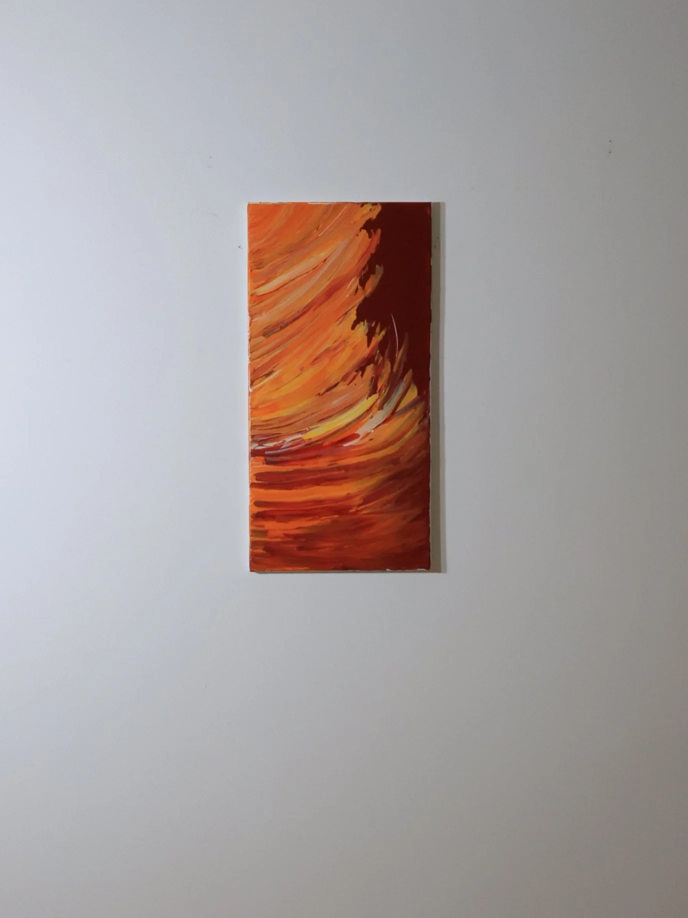 Abstract painting with swirling strokes of orange, red, yellow, and black on a rectangular canvas.