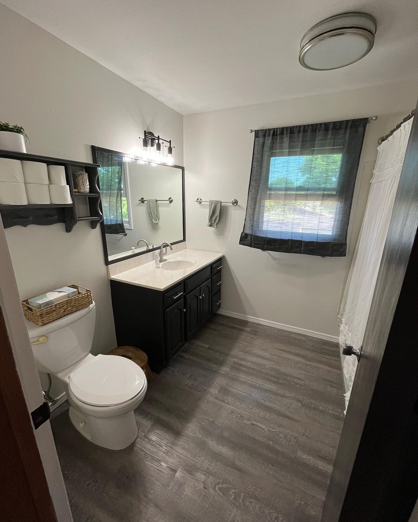 It rained really hard this week so I was trapped inside and next thing you know this project happened! I had some fun and remodeled our kids bathroom for about $90 total. Whoo!

New flooring (I used 2 mm vinyl peel &amp; stock storm gray planks), Pai
