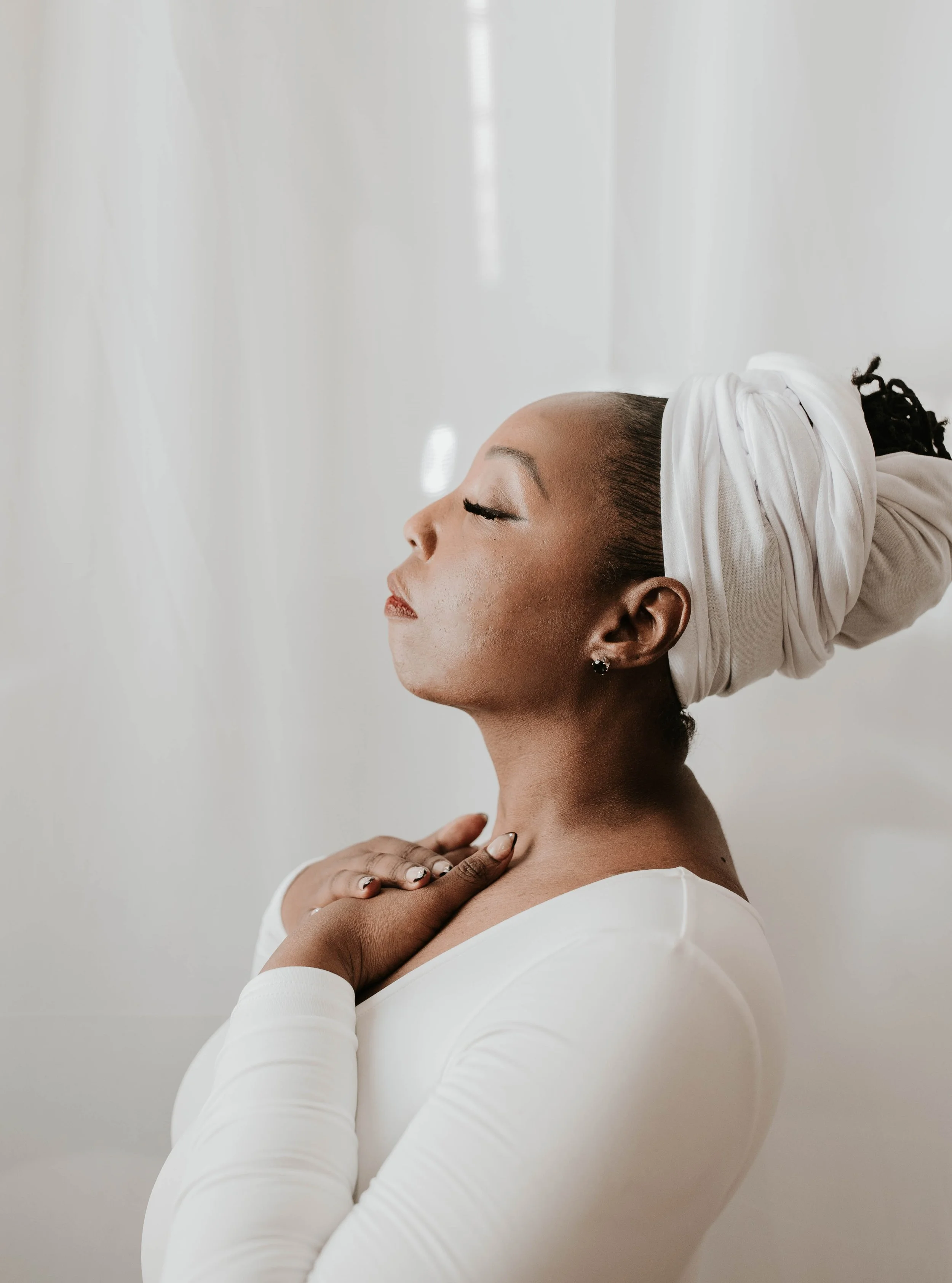 Towanda Carrigan in a reflective pose representing self-awareness, alignment, and divine purpose through the 2Wanda Community Foundation