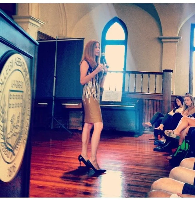 Modern house with wooden exterior, stone steps, and a mountain landscape in the background.