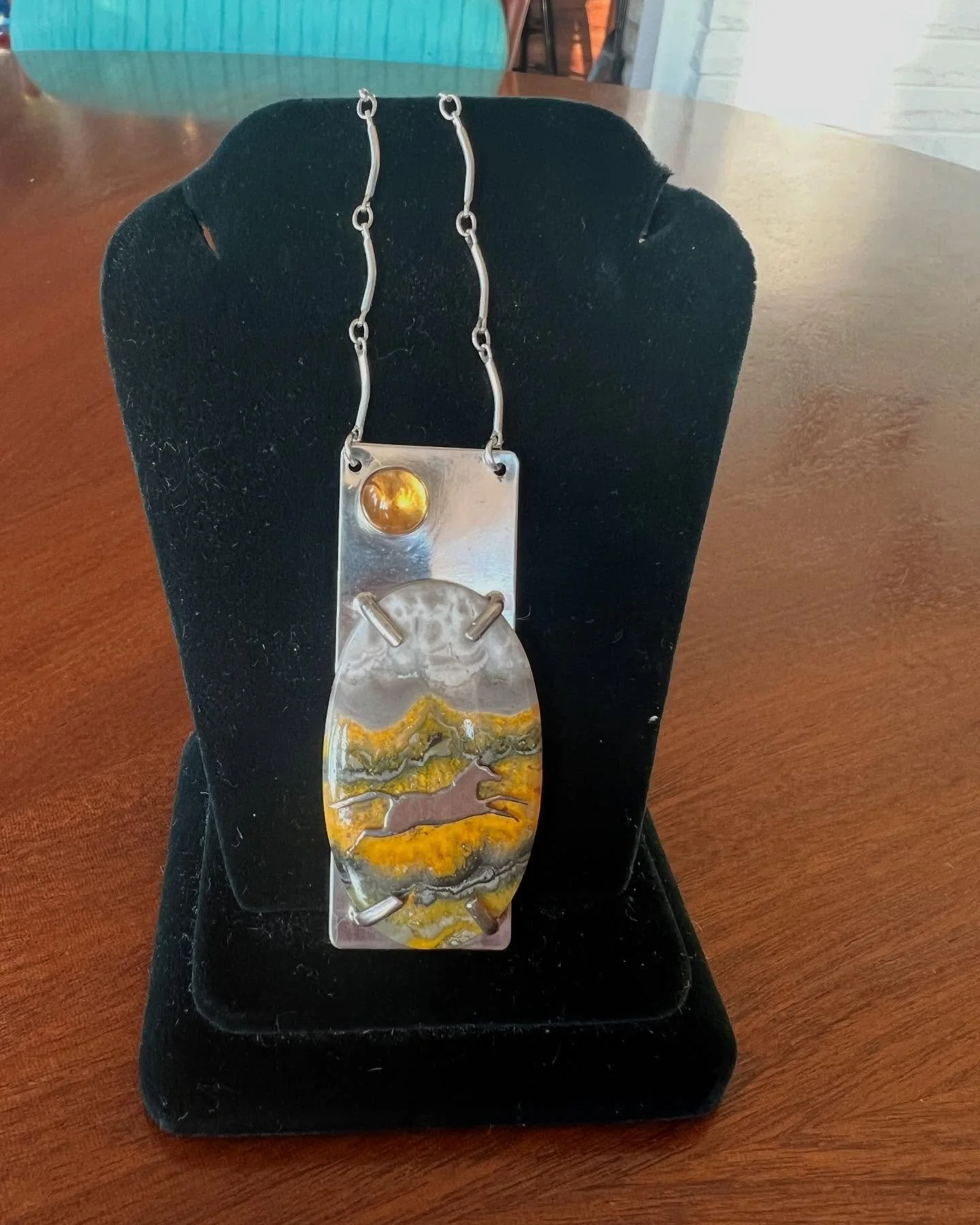 Today&rsquo;s featured auction piece is truly unique and perfect for Derby season! It&rsquo;s a sterling silver horse set in an oval bumblebee jasper disc set on sterling silver that has a cabochon cut yellow stone as well. The pendant is set on link
