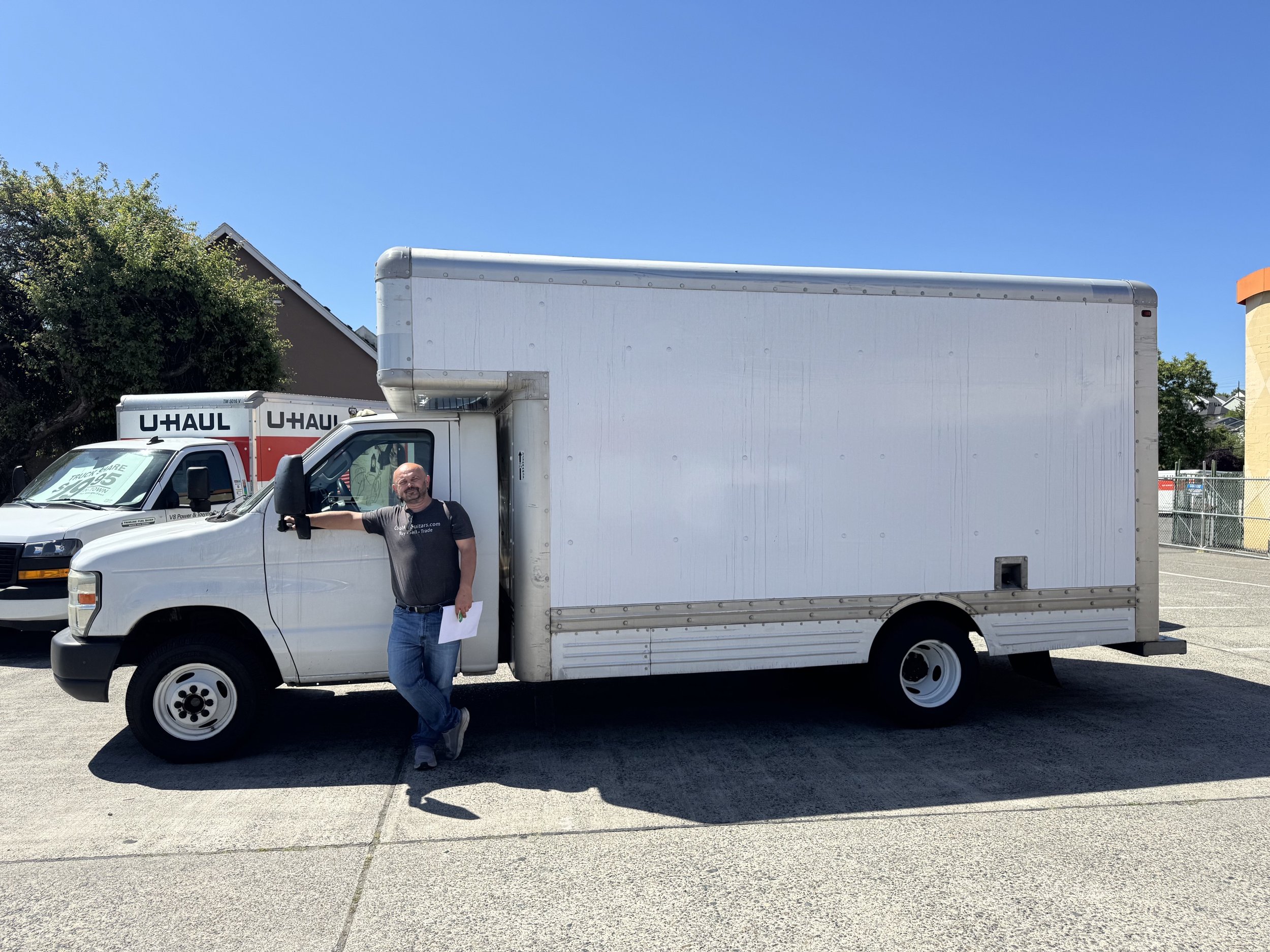 man standing in front of white box truck