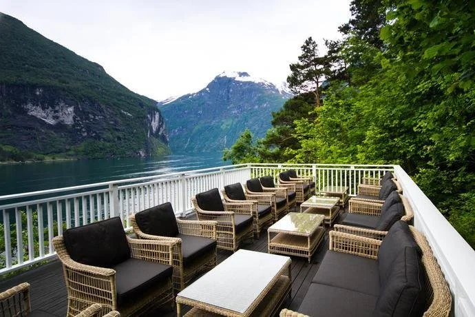 An open-air lounge area overlooking the Geirangerfjord in Norway