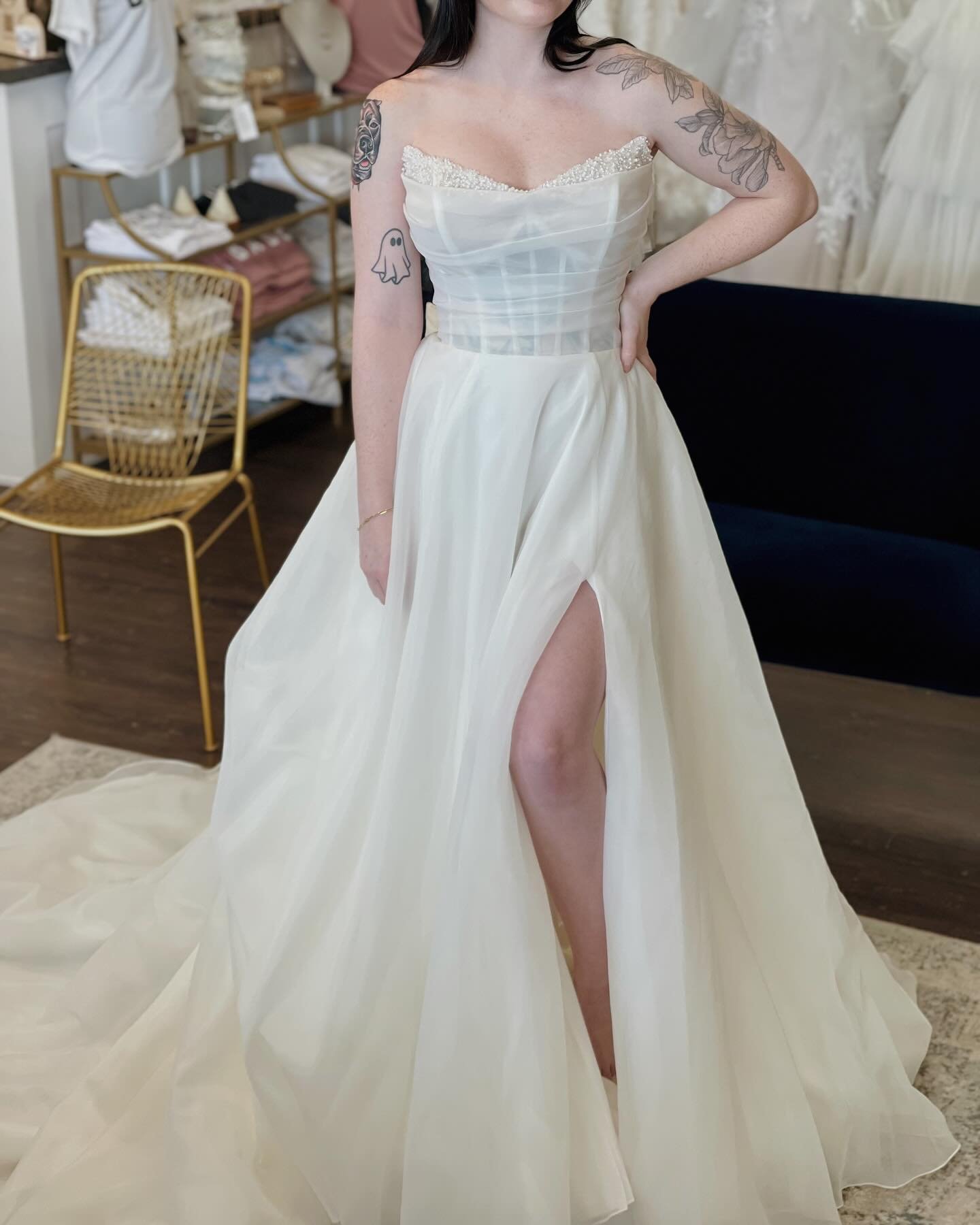 We are so excited about this new arrival!!

This beautiful strapless a-line has a modern scoop neck that is scattered with pearl and crystals. The organza pleated bodice shows off the sheet boned corset look underneath. Having a slit in the skirt bre