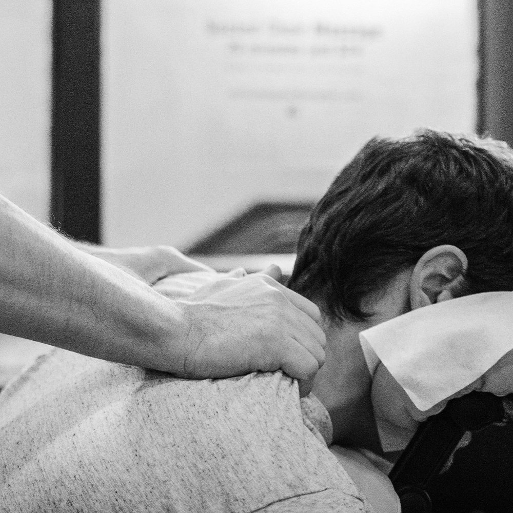  a man receives relaxing massage therapy to his neck and shoulders during an employee appreciation day 