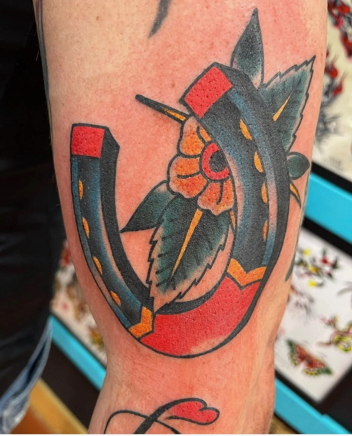 colored american traditional horseshoe done by cody wallenius at easy tiger tattoo in merrillville indiana