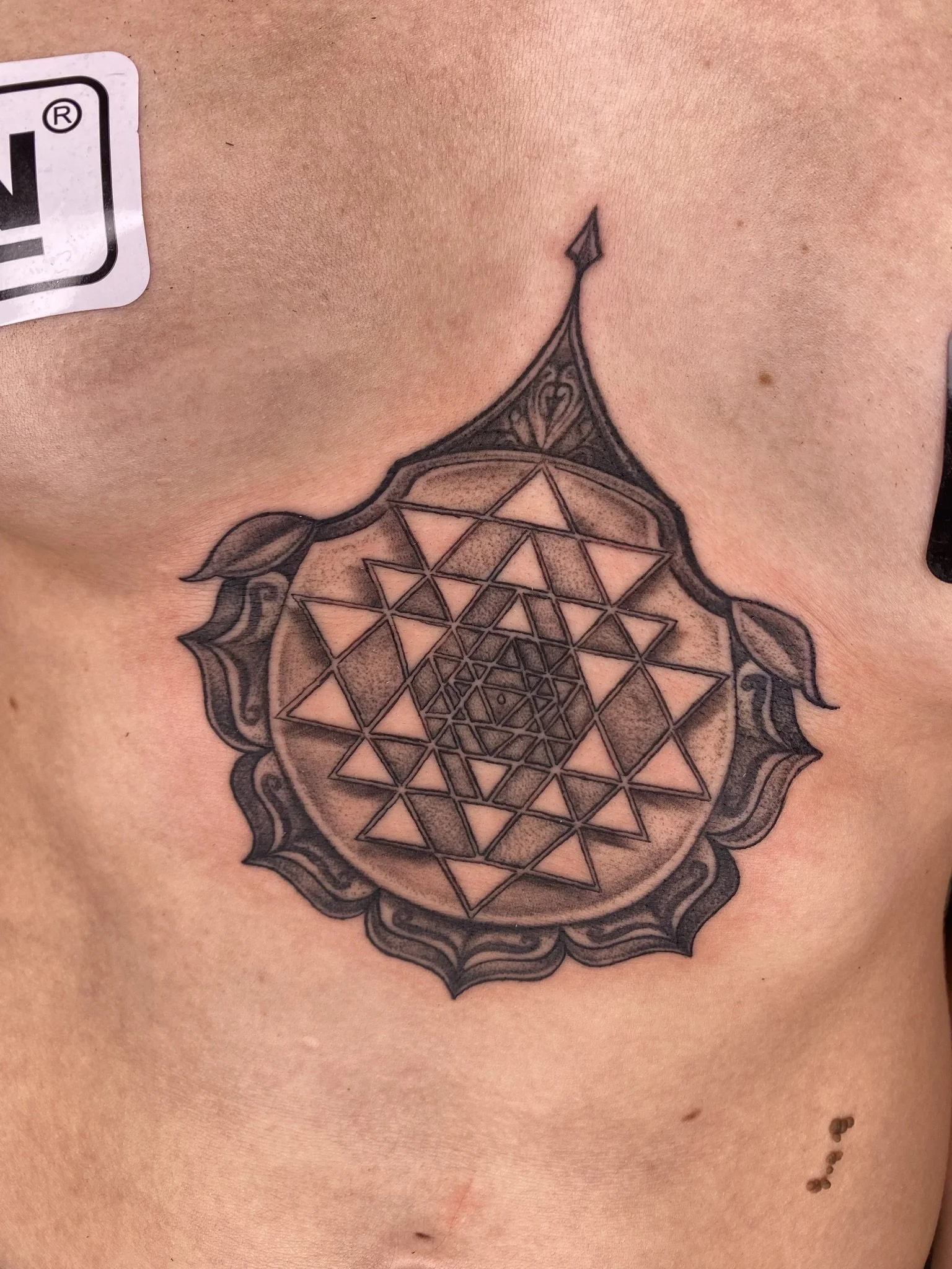 blackwork sternum mandala done by sterling gorejus at easy tiger tattoo in merrillville indiana 