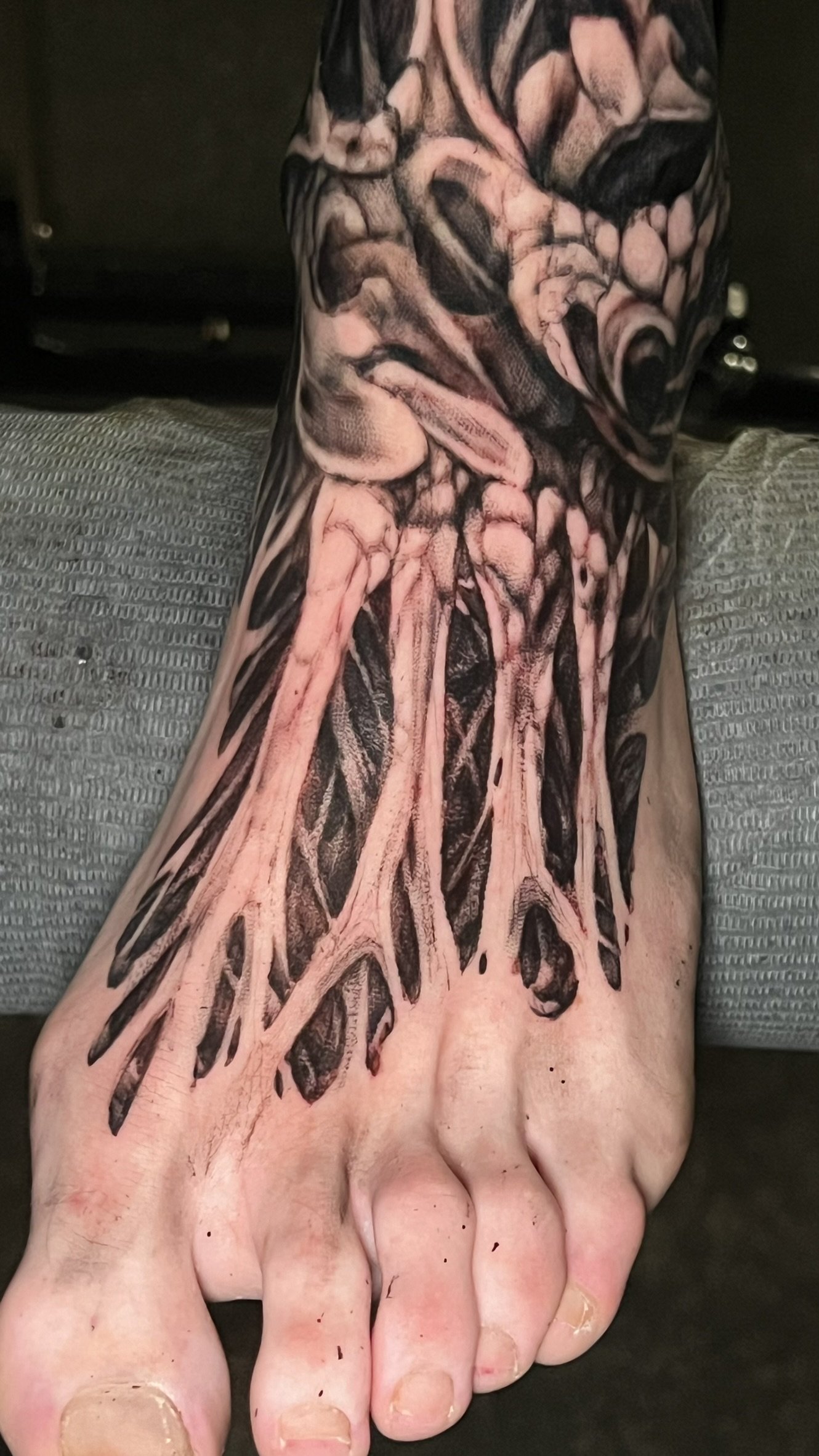 blackwork organic skeletal foot tattoo done by sterling gorejus at easy tiger tattoo in merrillville indina