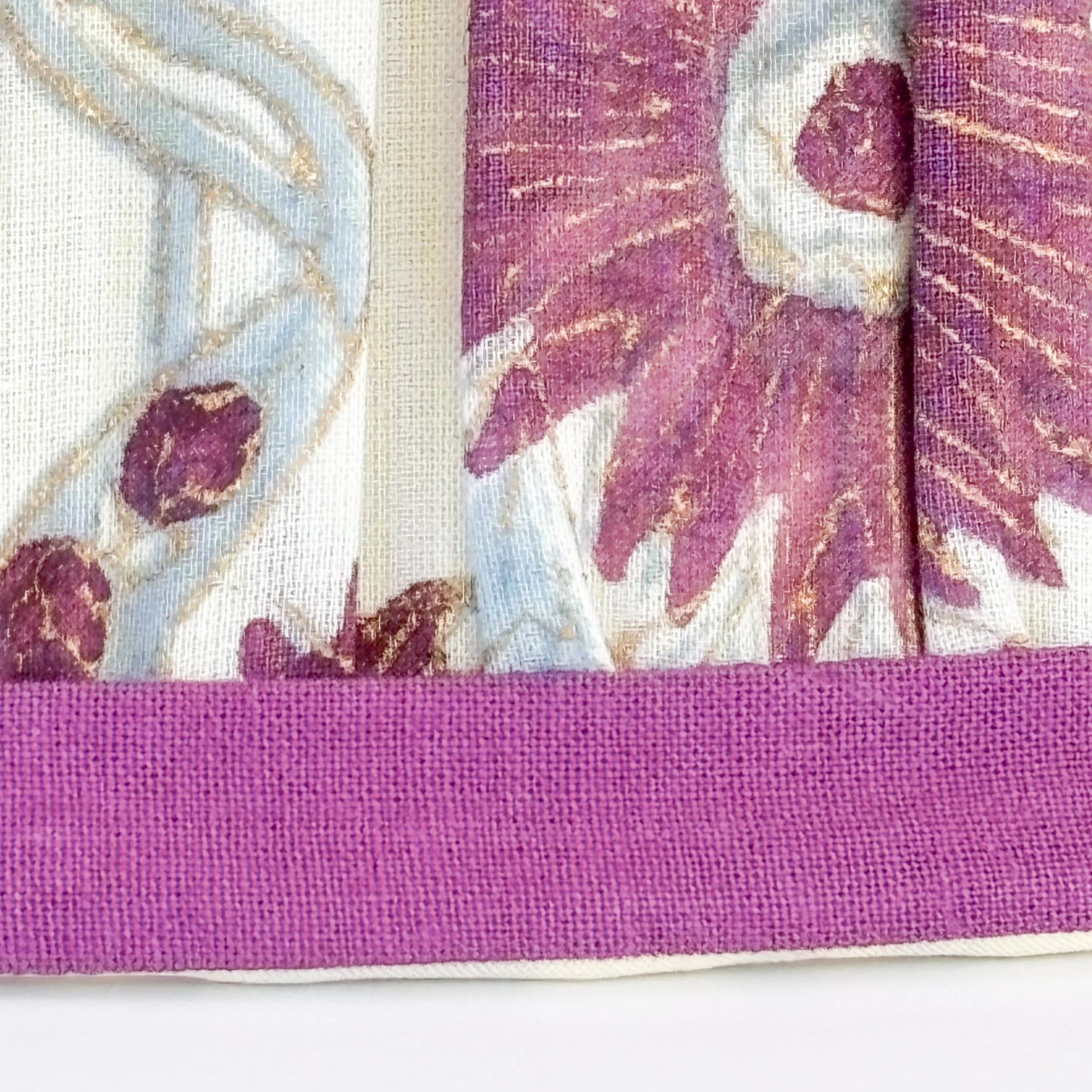 Floral pleated lampshades with purple borders shown together.