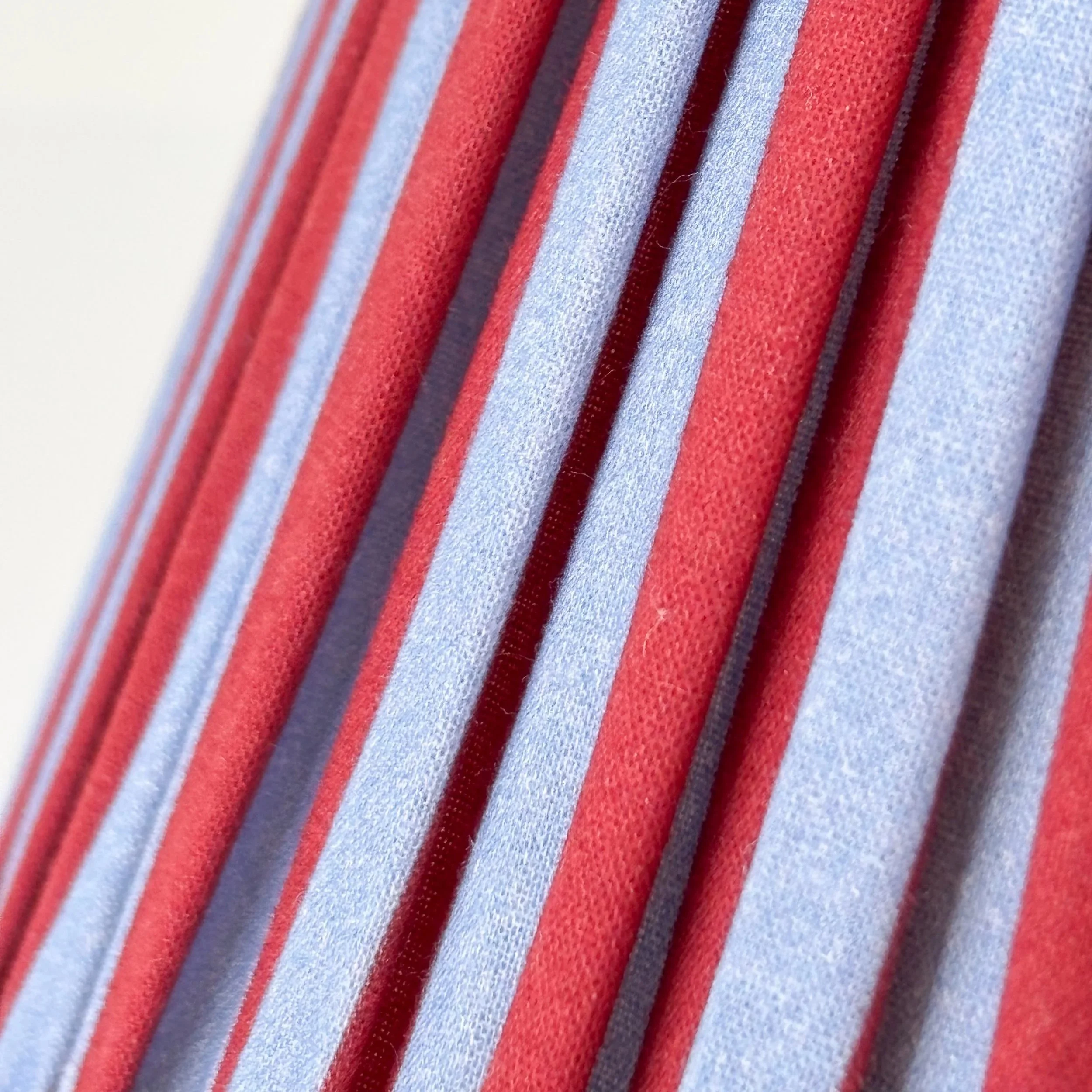 Decorative Red and Blue Pleated Lampshade photographed against a white background.